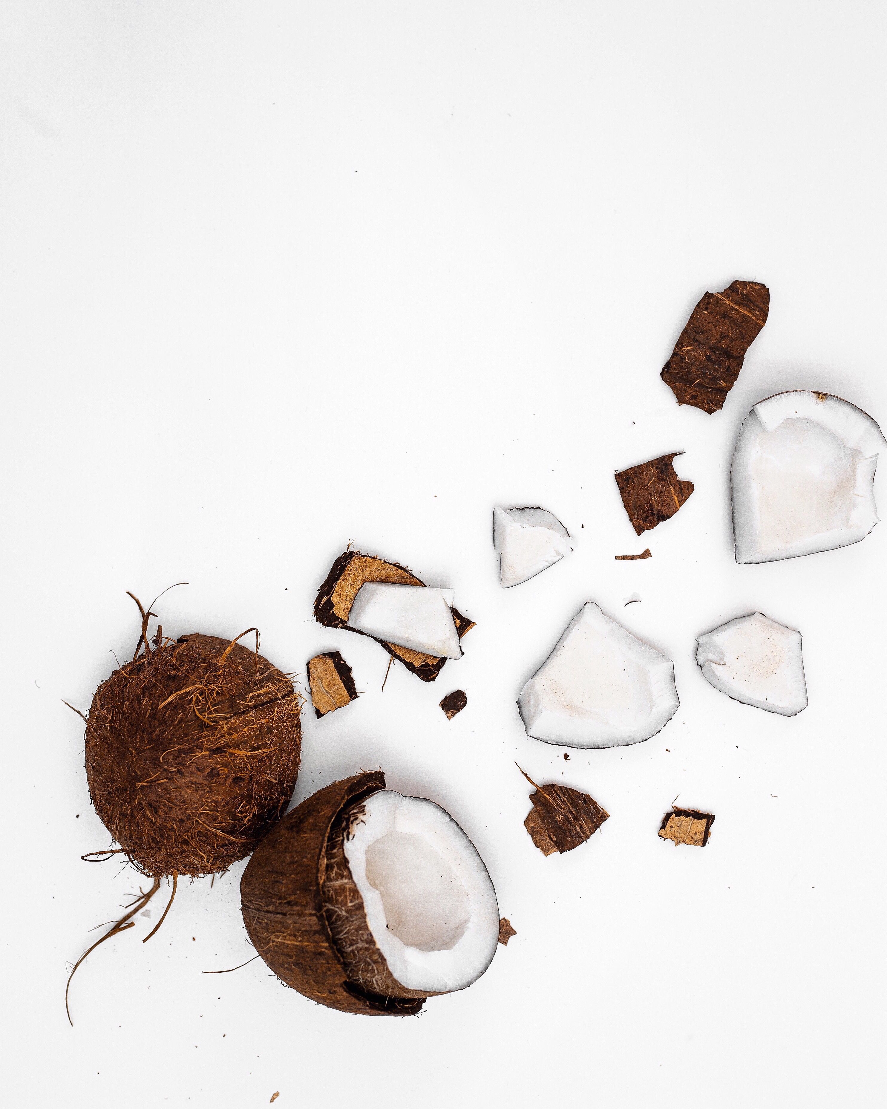 A coconut is being split open on the ground - Coconut