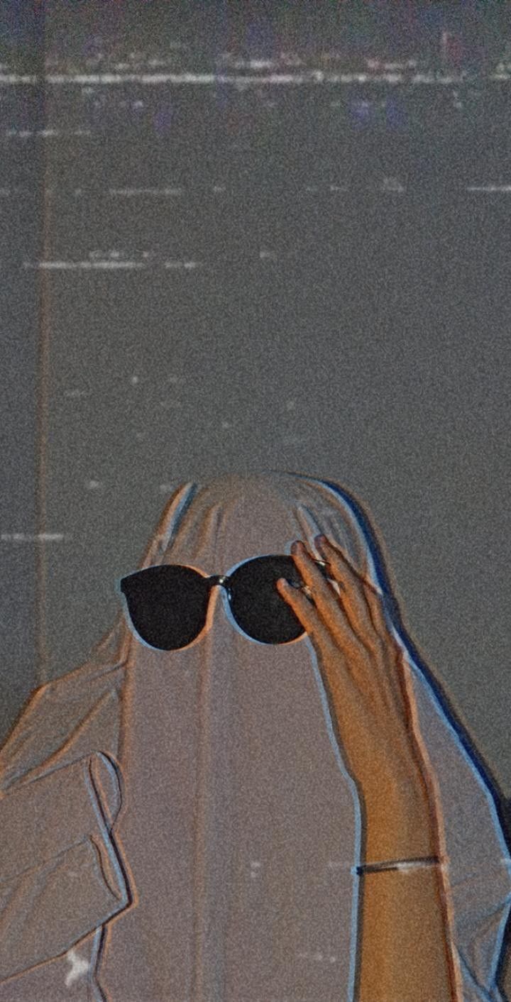 A person with sunglasses covering their face - Ghost