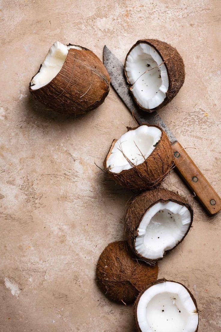 A coconut and knife on the table - Coconut