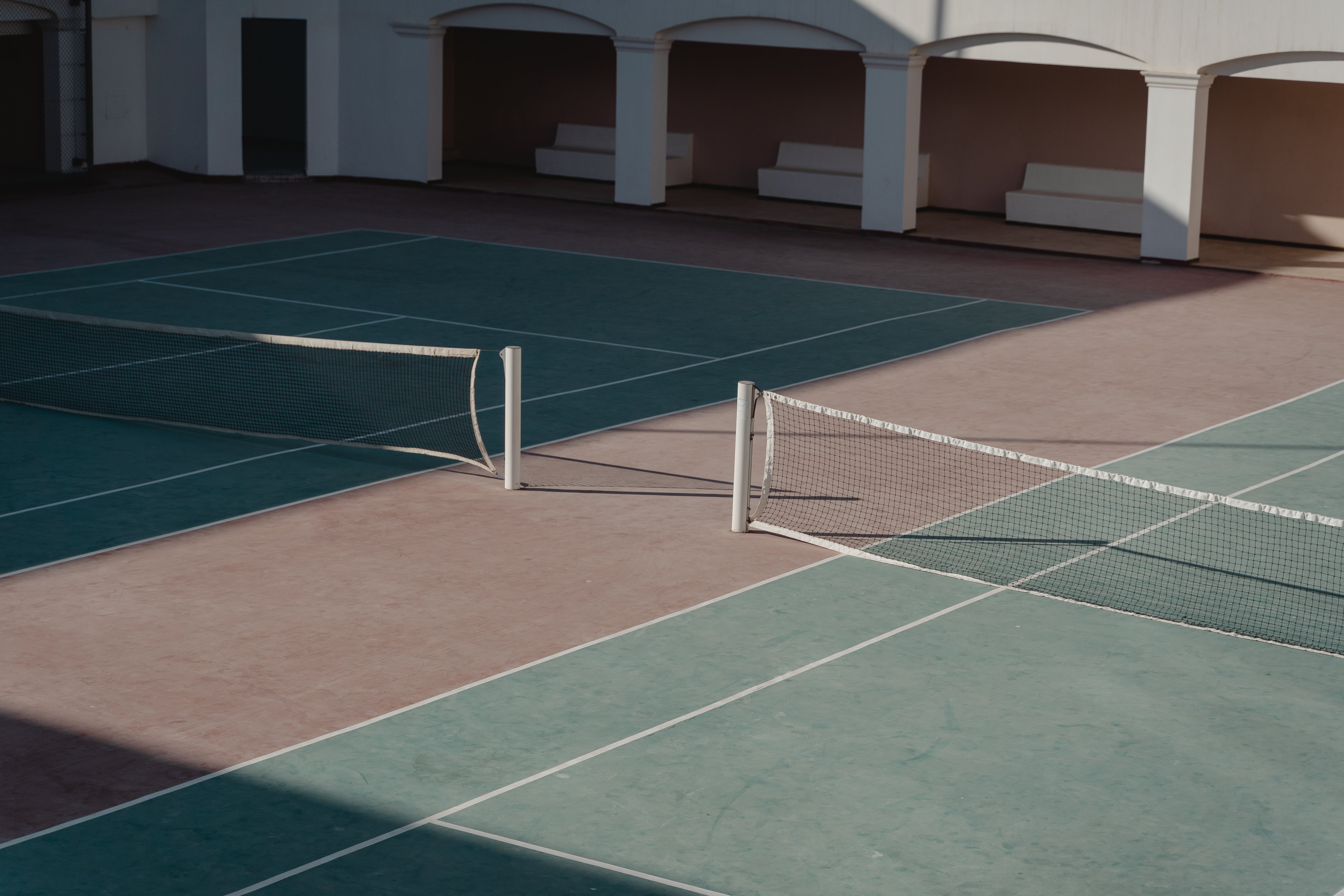 A tennis court with two tennis nets set up on it - Tennis