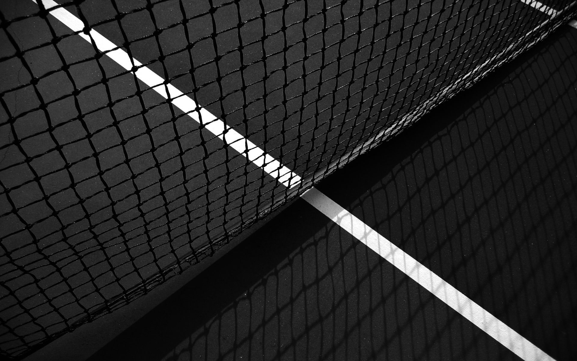 A tennis court with a net and a white line - Tennis