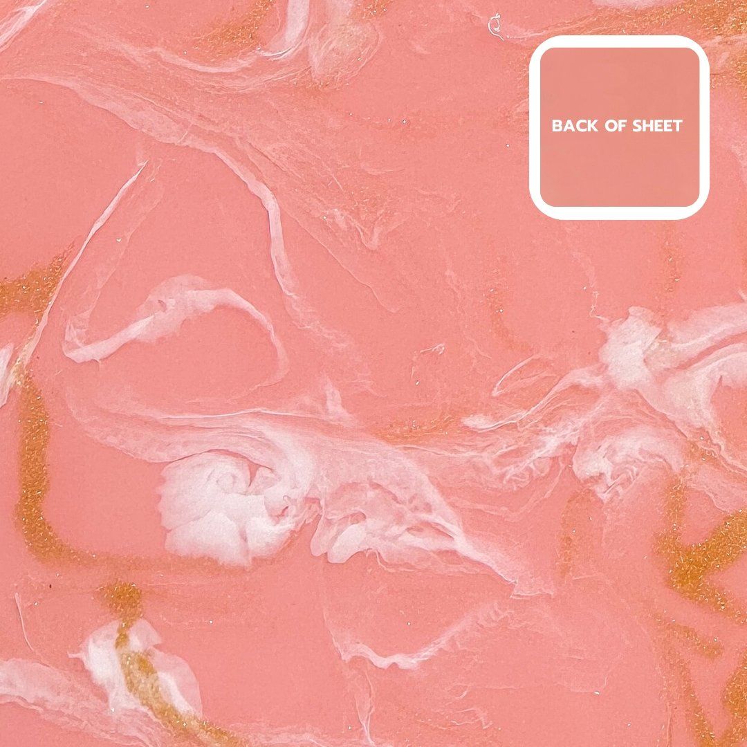 A pink and white marbled surface with a gold sheen and a white square with the text 