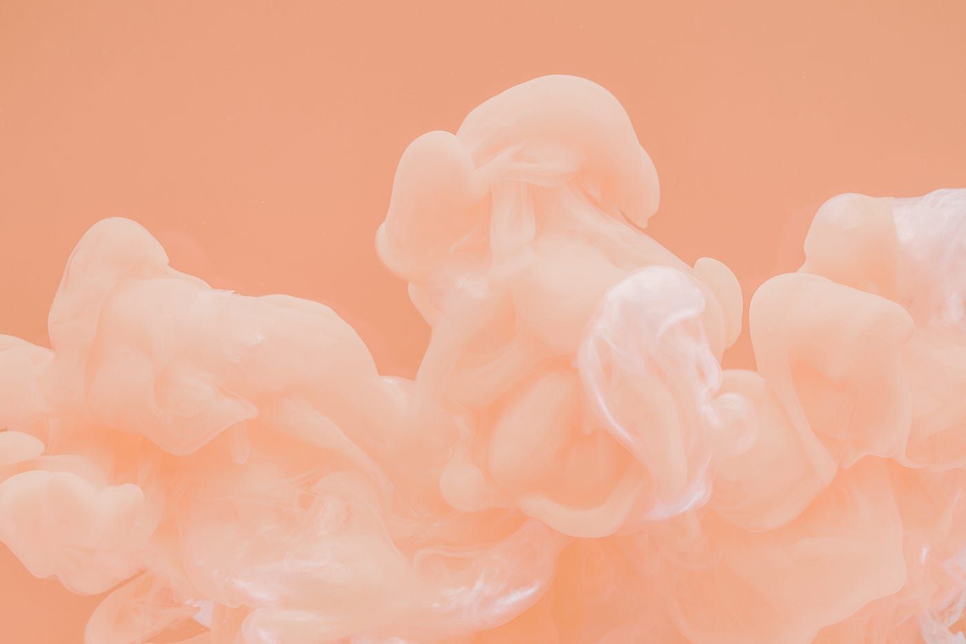A pink and white smoke cloud against a pink background - Salmon