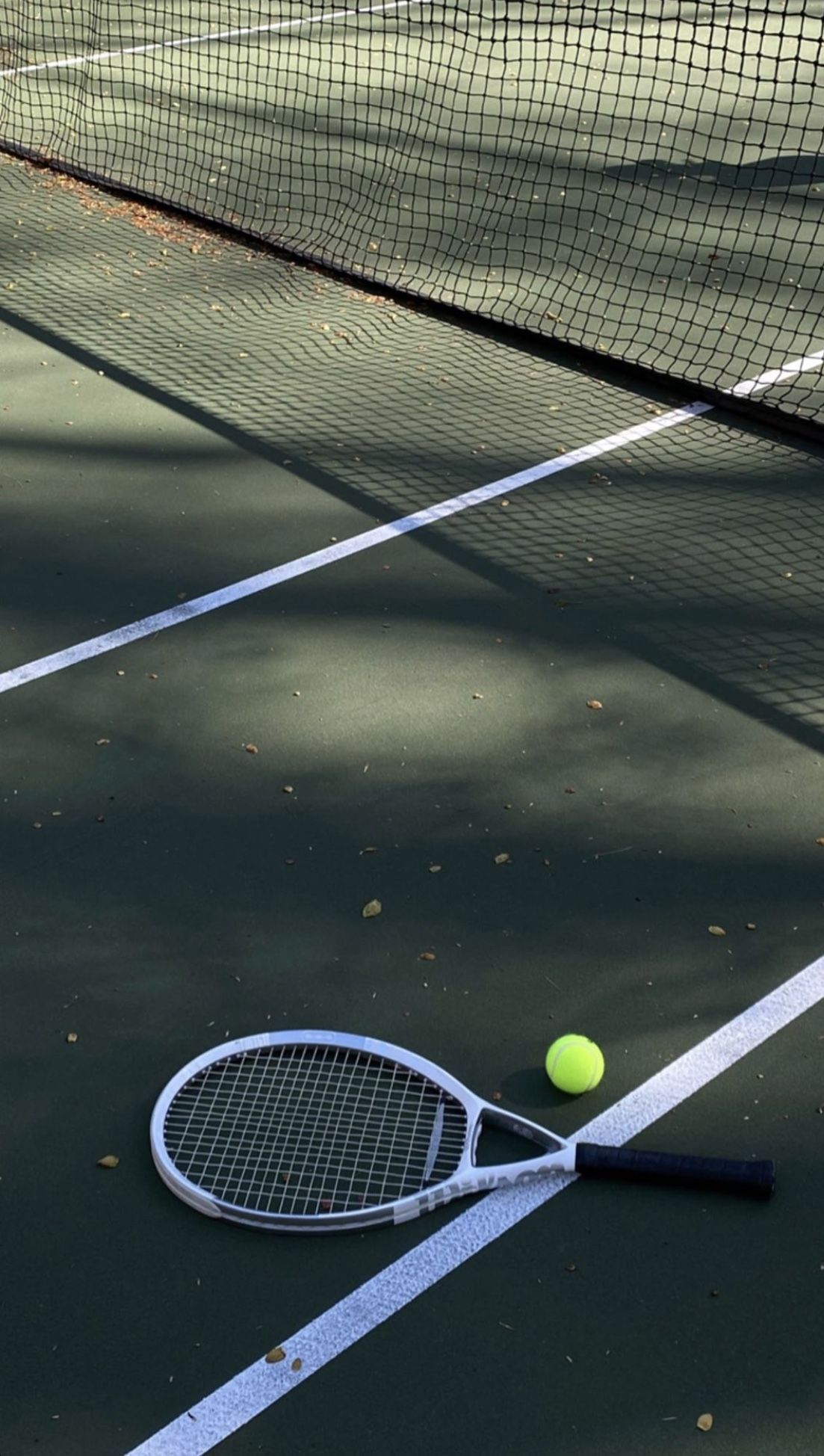 A tennis racket and ball on the court - Tennis
