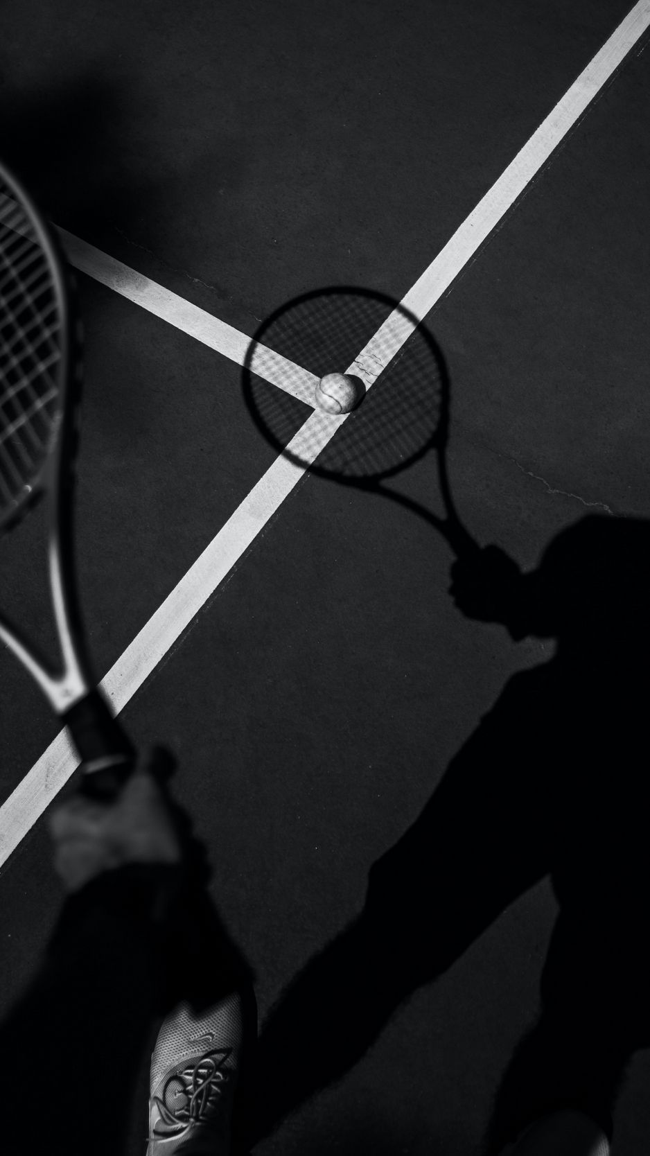 A person holding two tennis rackets on the court - Tennis