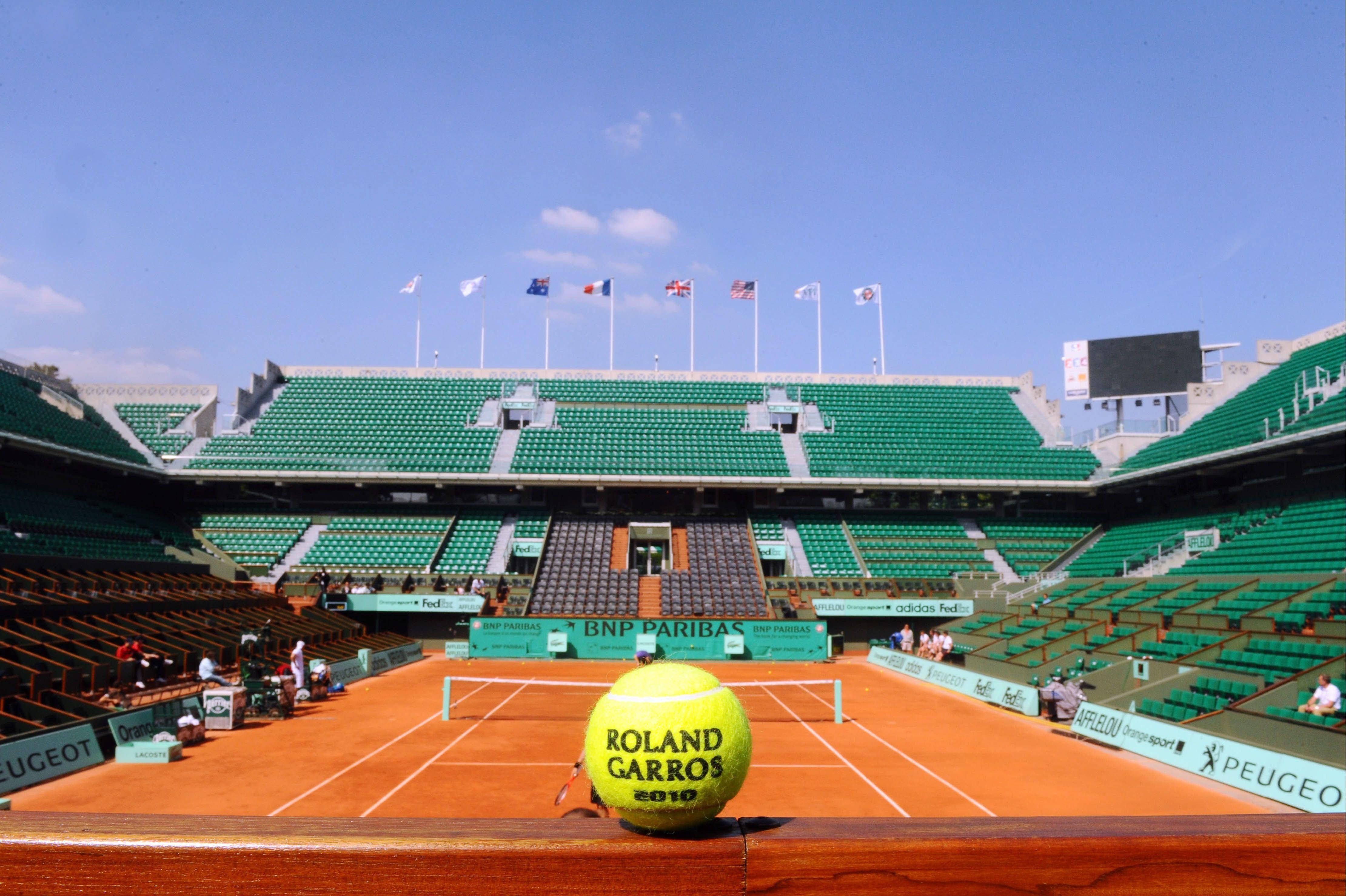 Download Tennis Ball Against French Open Court Wallpaper