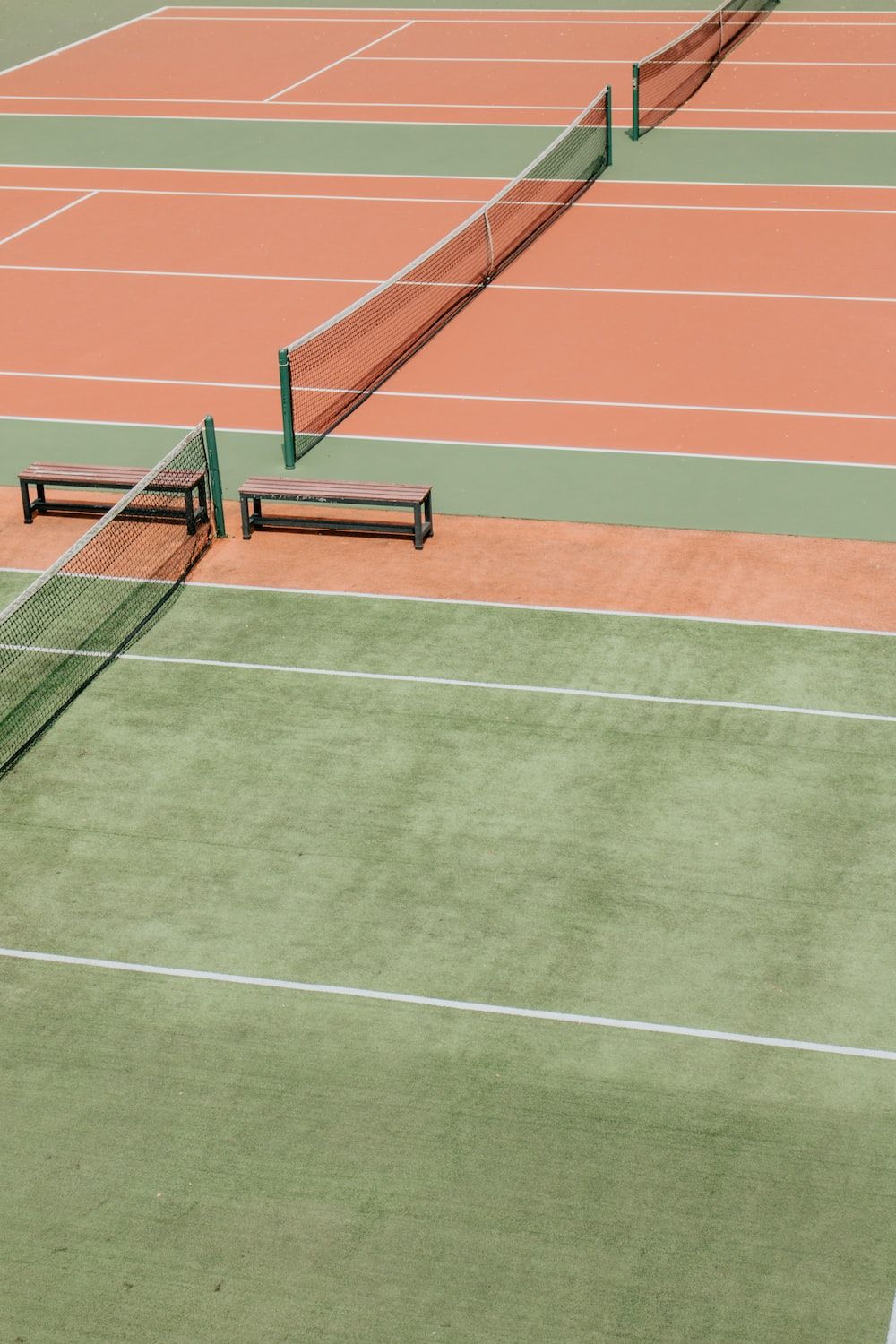 Aerial view of a tennis court with two benches - Tennis