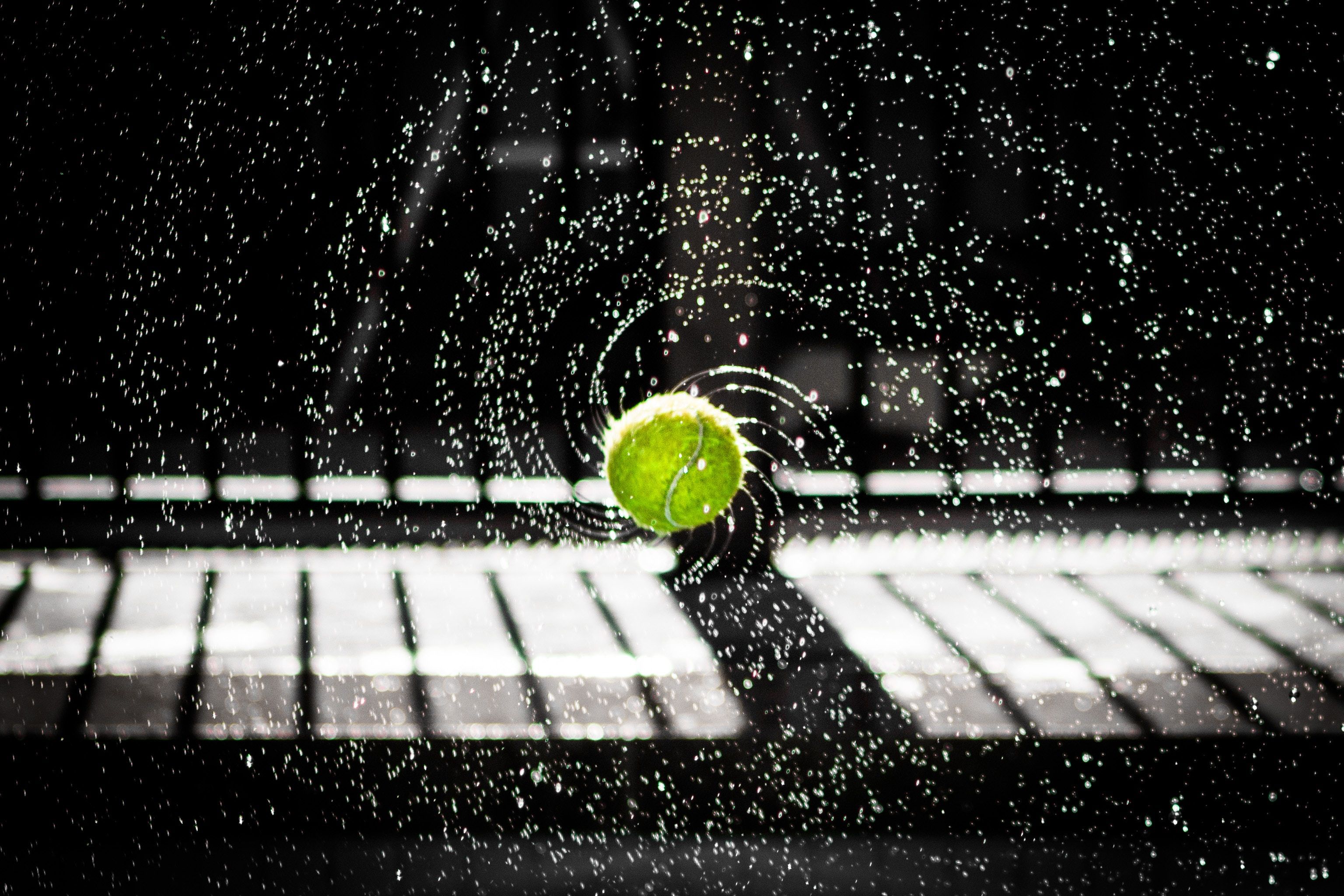 A tennis ball colliding with a computer keyboard - Tennis