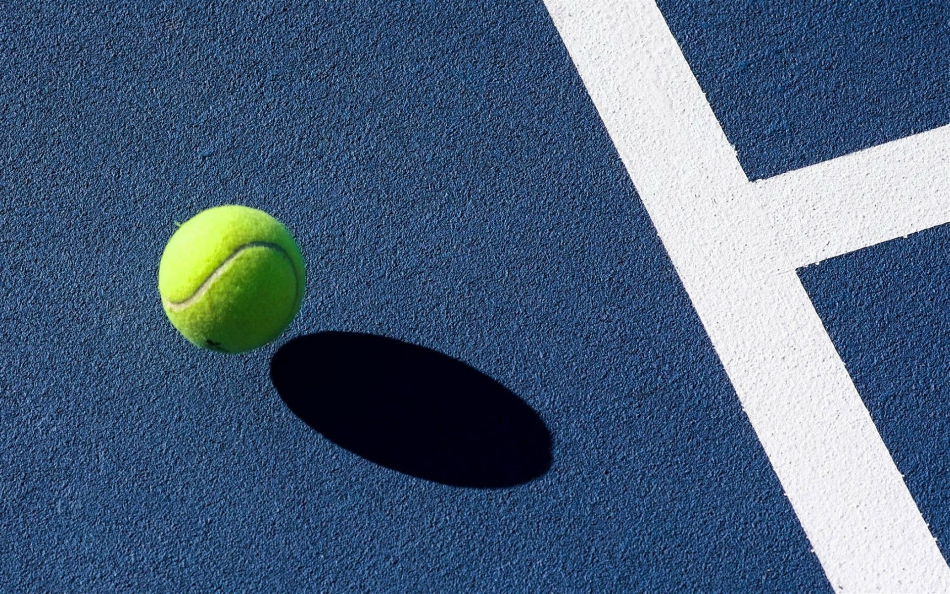 A tennis ball sitting on top of the court - Tennis