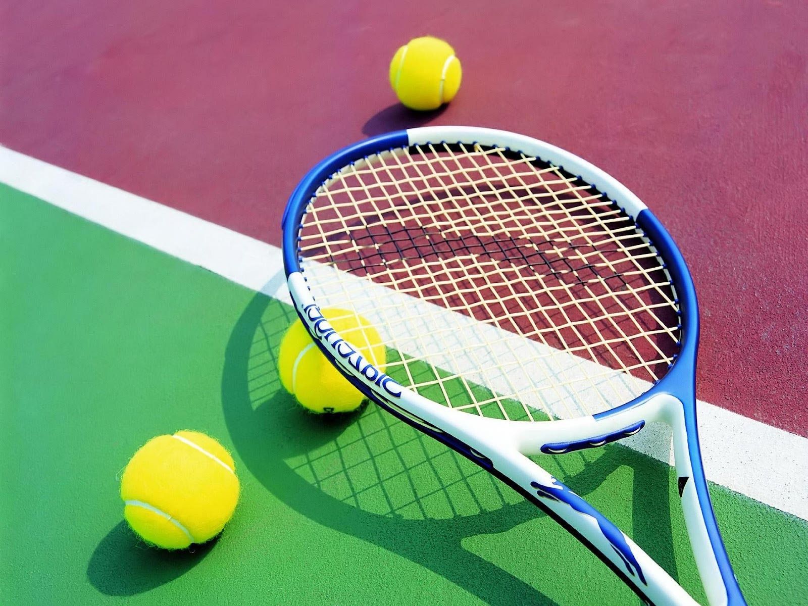 A tennis racket and three yellow balls on the court - Tennis