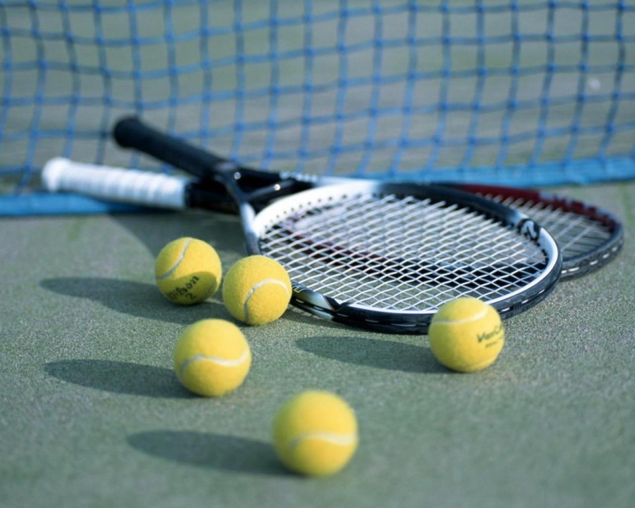 A tennis racket and balls on the ground - Tennis