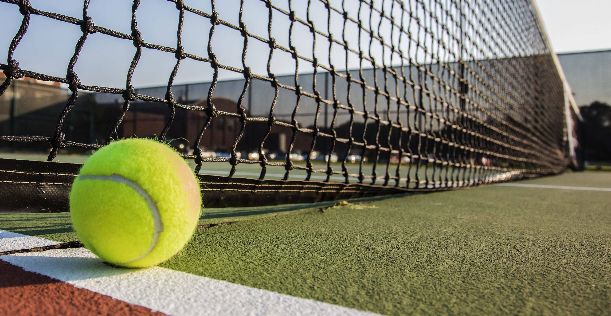 A tennis ball sitting on the court - Tennis