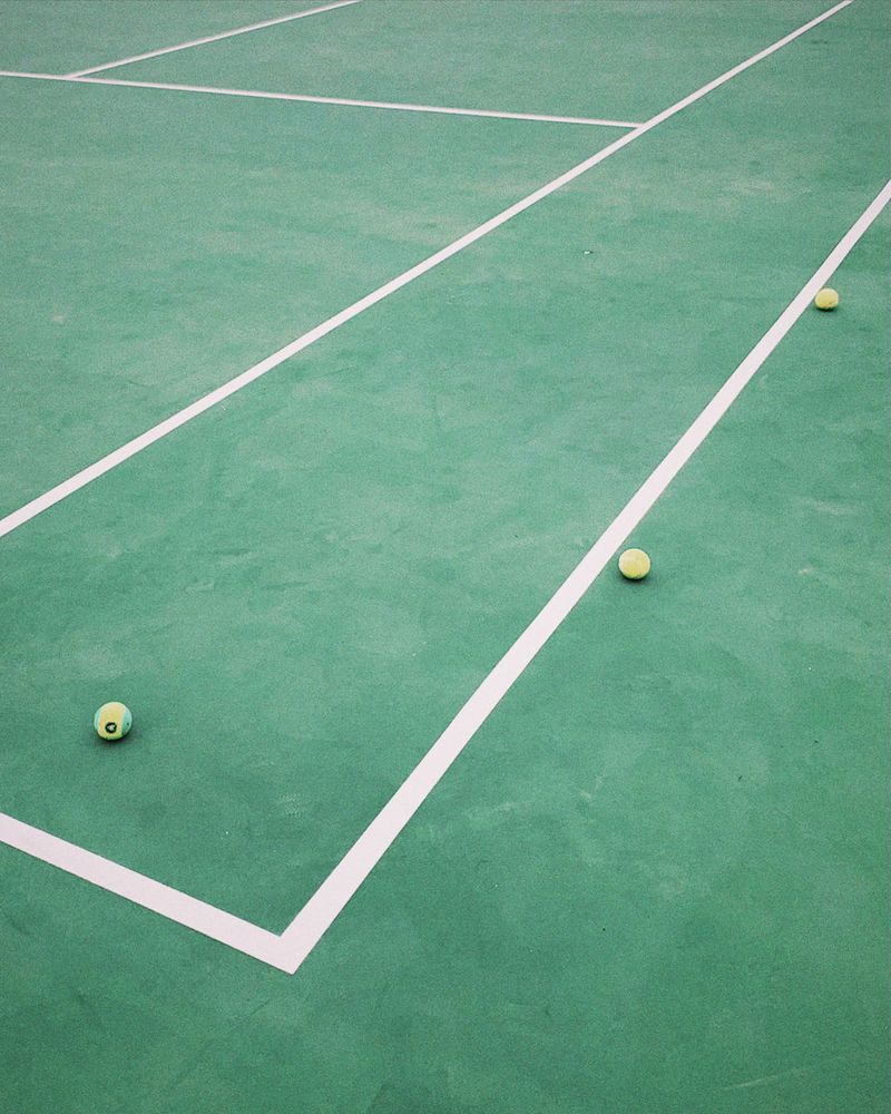 A tennis court with tennis balls on it - Tennis