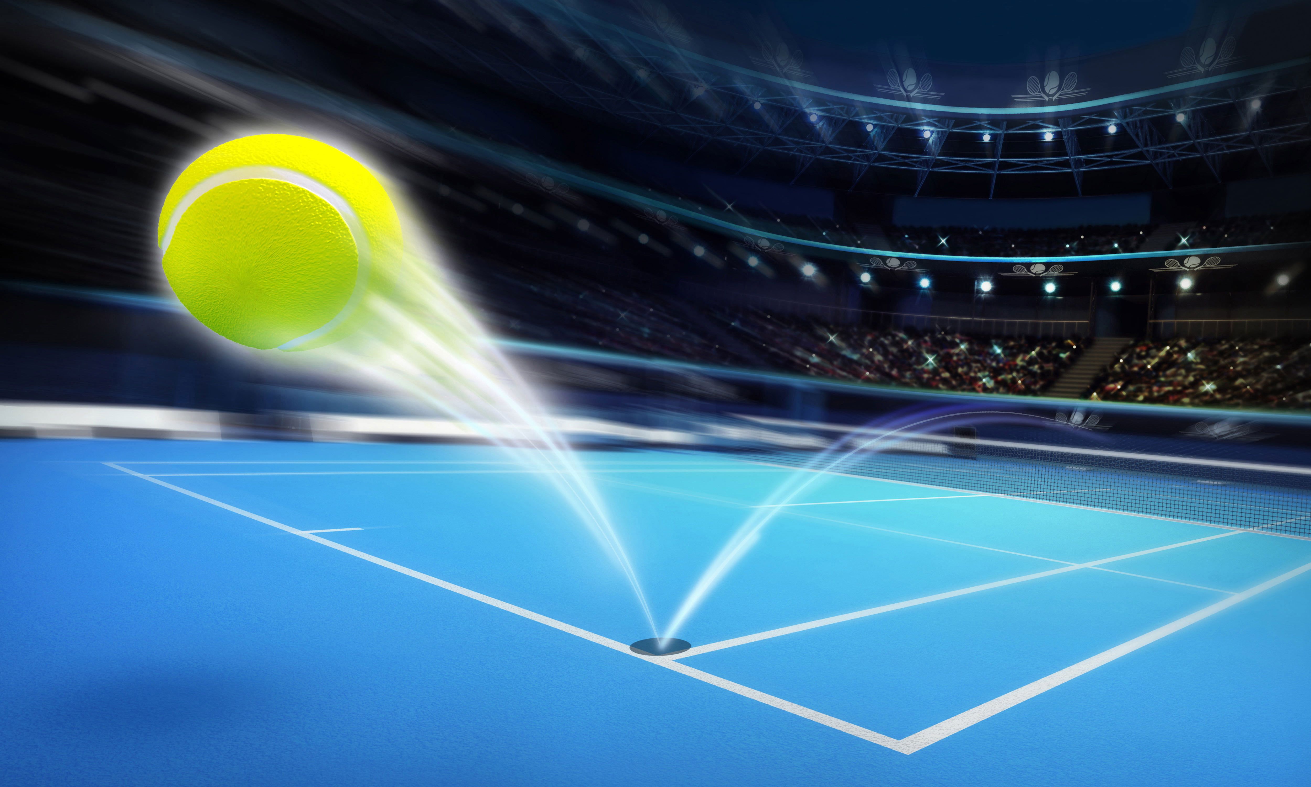 A tennis ball flying over a net on a blue court - Tennis