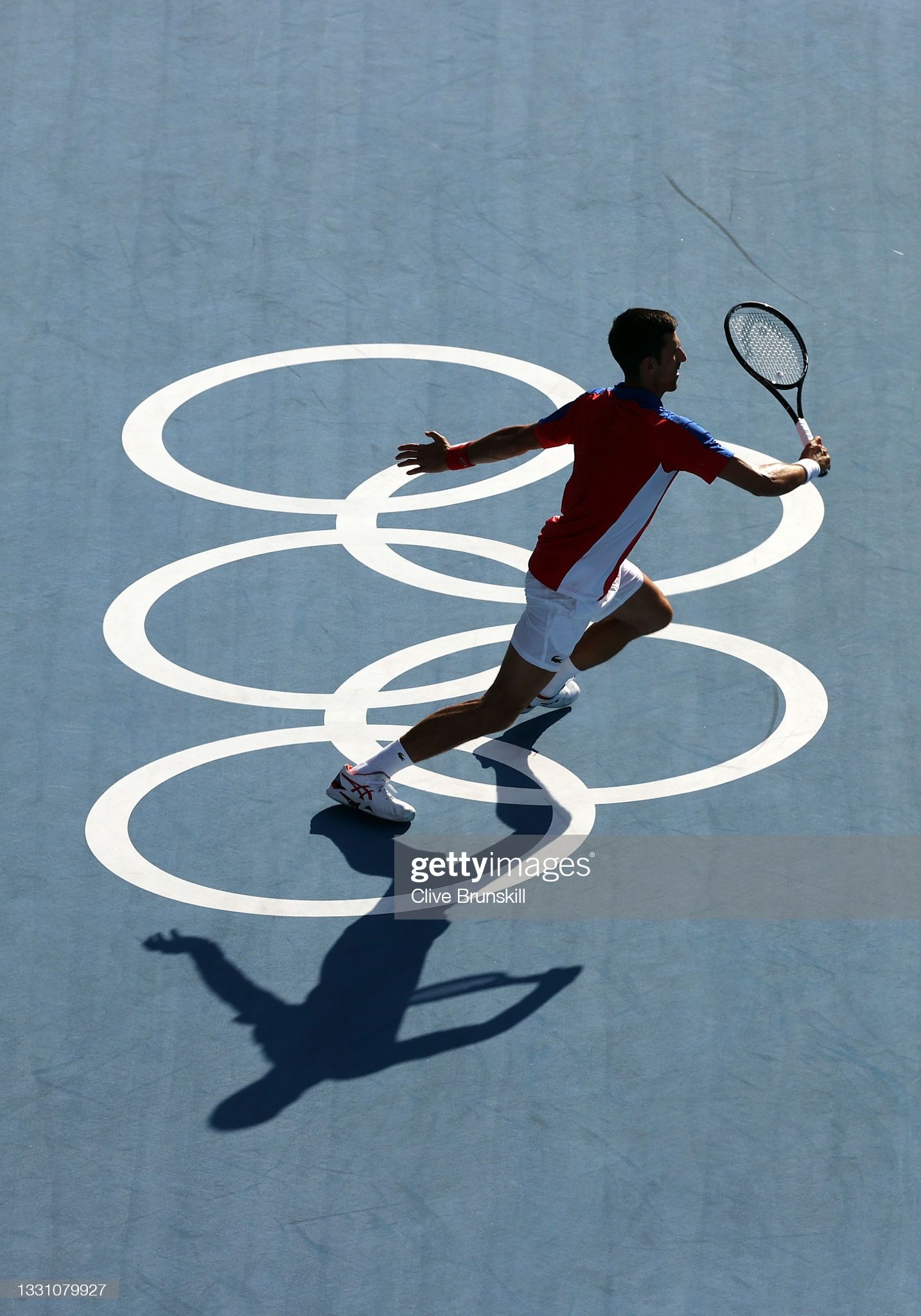 Novak Djokovic of Serbia plays a shot against Juan Martin Del Potro of Argentina during the men's singles gold medal match on Day 15 of the London 2012 Olympic Games at the All England Lawn Tennis and Croquet Club on August 11, 2012 in London, England. - Tennis