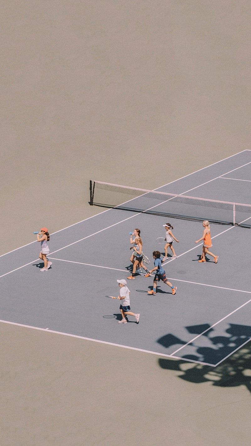 A group of people playing tennis on the court - Tennis