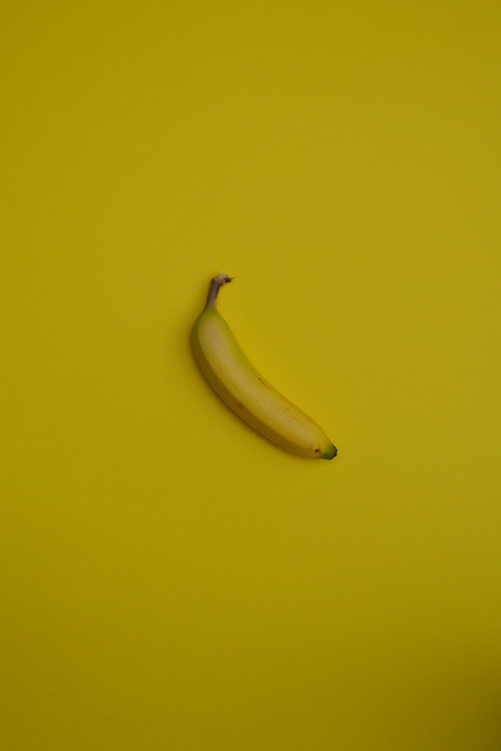 yellow banana fruit on yellow surface photo