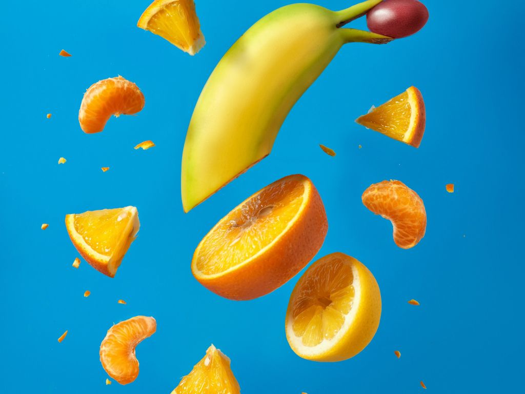 A banana and some fruit are falling from the sky - Banana