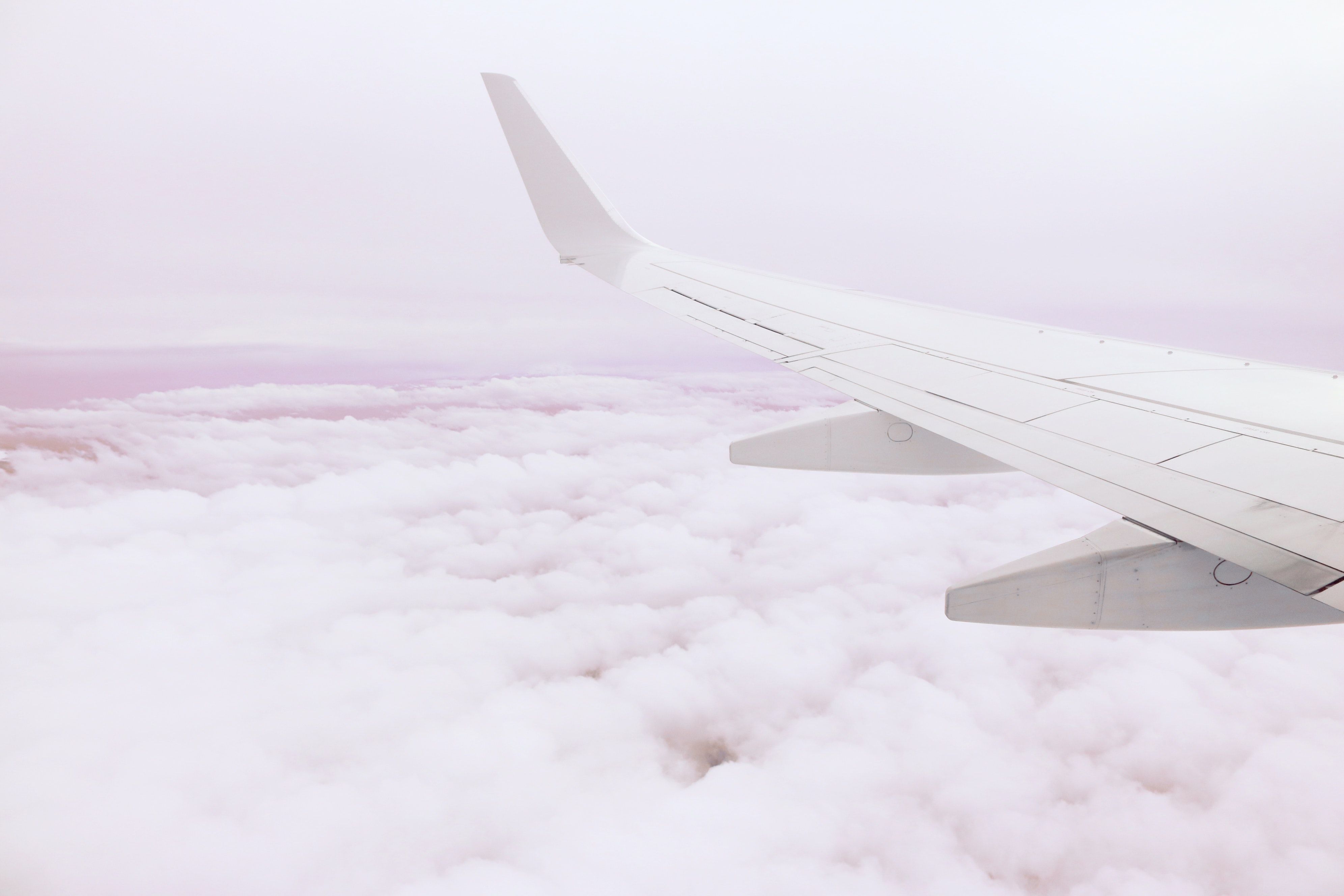 Mountains and Clouds Outside of an Airplane Window · Free