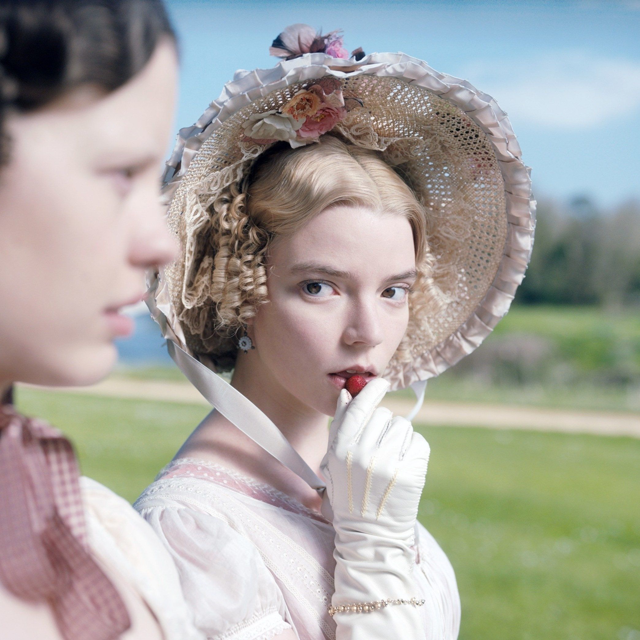 Florence Pugh as Amy March in Little Women (2019) holding a strawberry to her lips - Anya Taylor-Joy