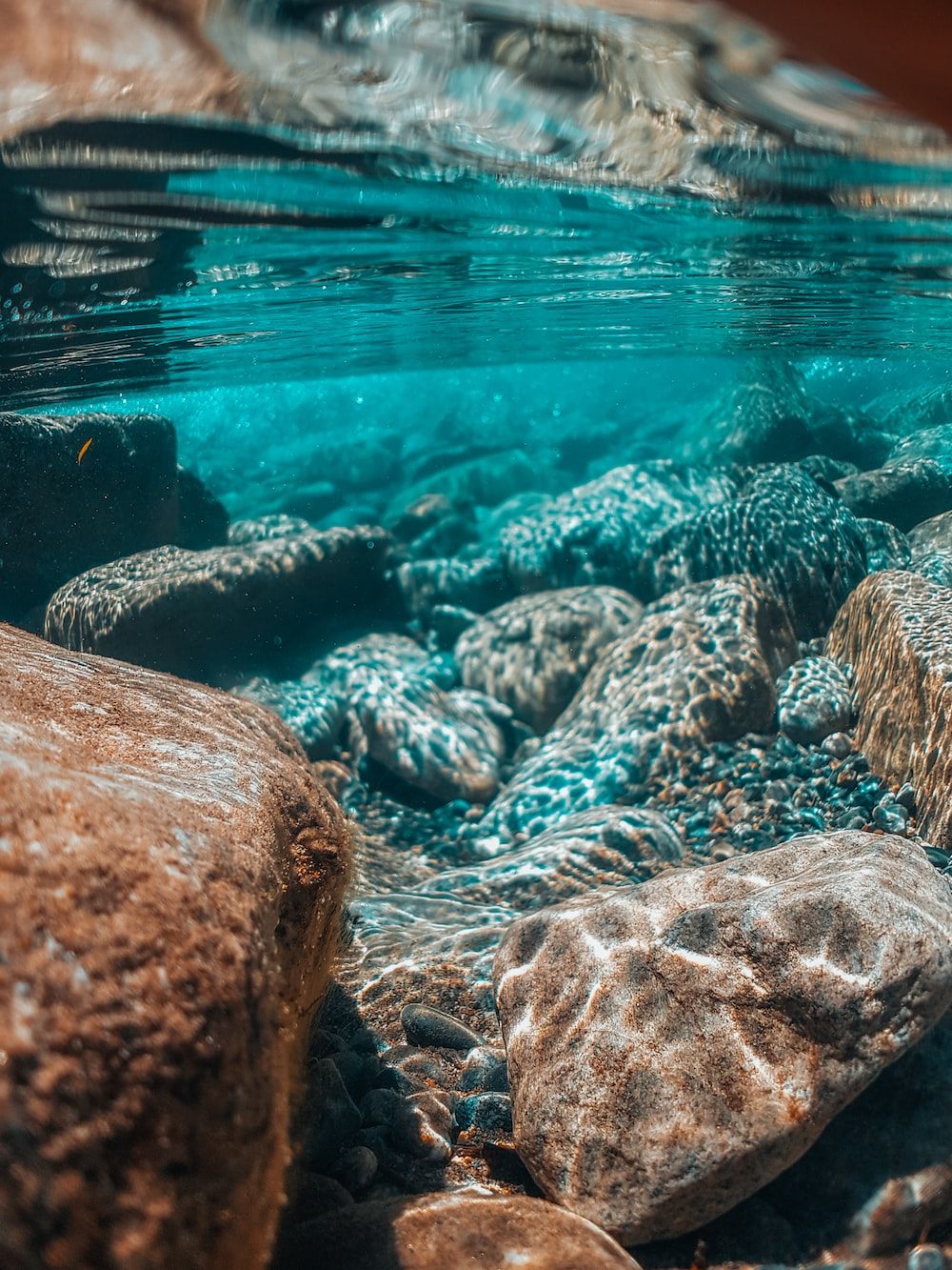 A view of rocks and water from under the surface - Underwater