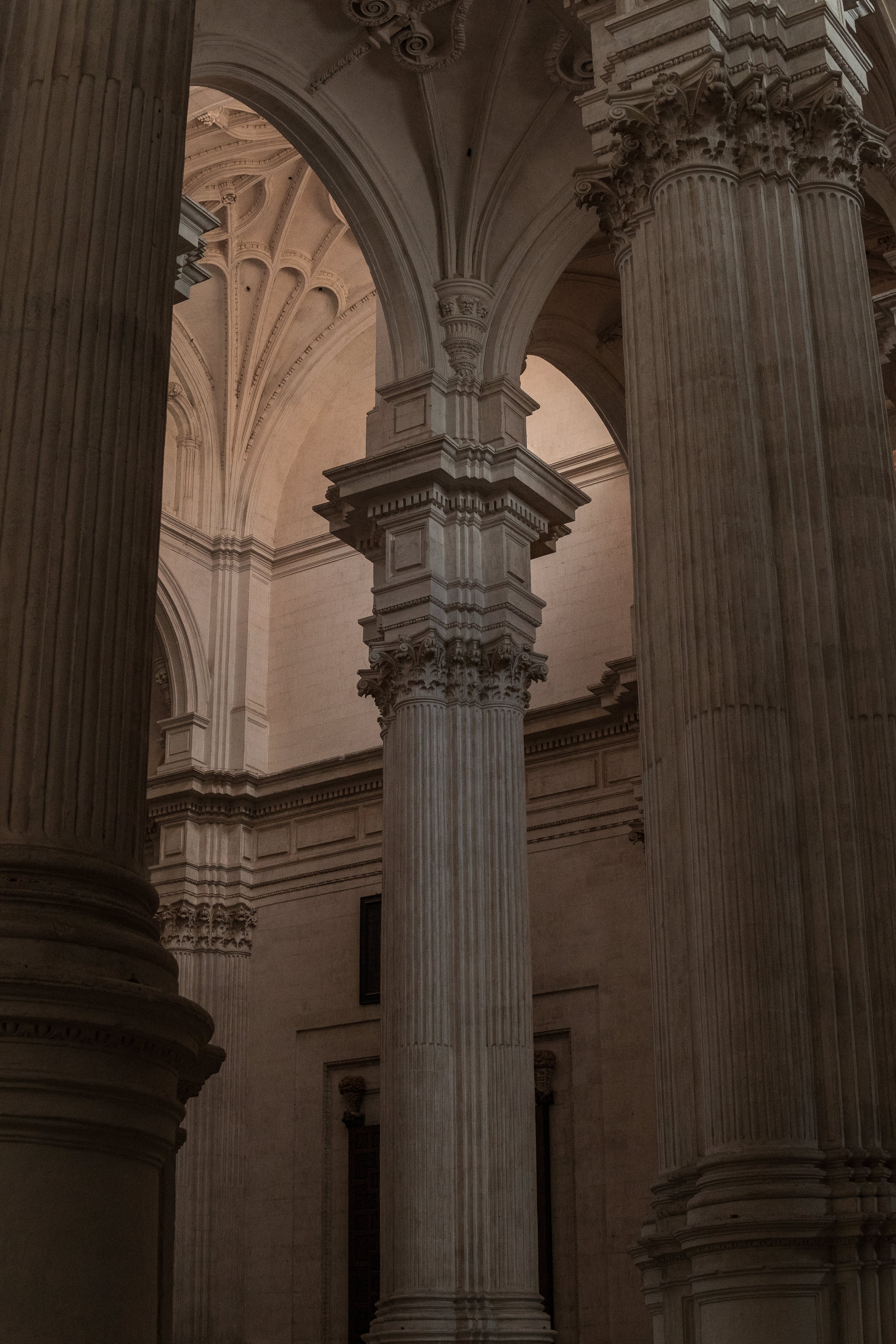 A photograph of a cathedral with three large white columns. - Light academia