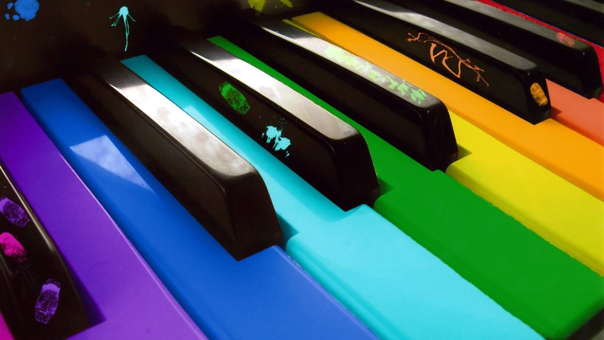 A colorful piano with the keys painted in various colors. - Piano