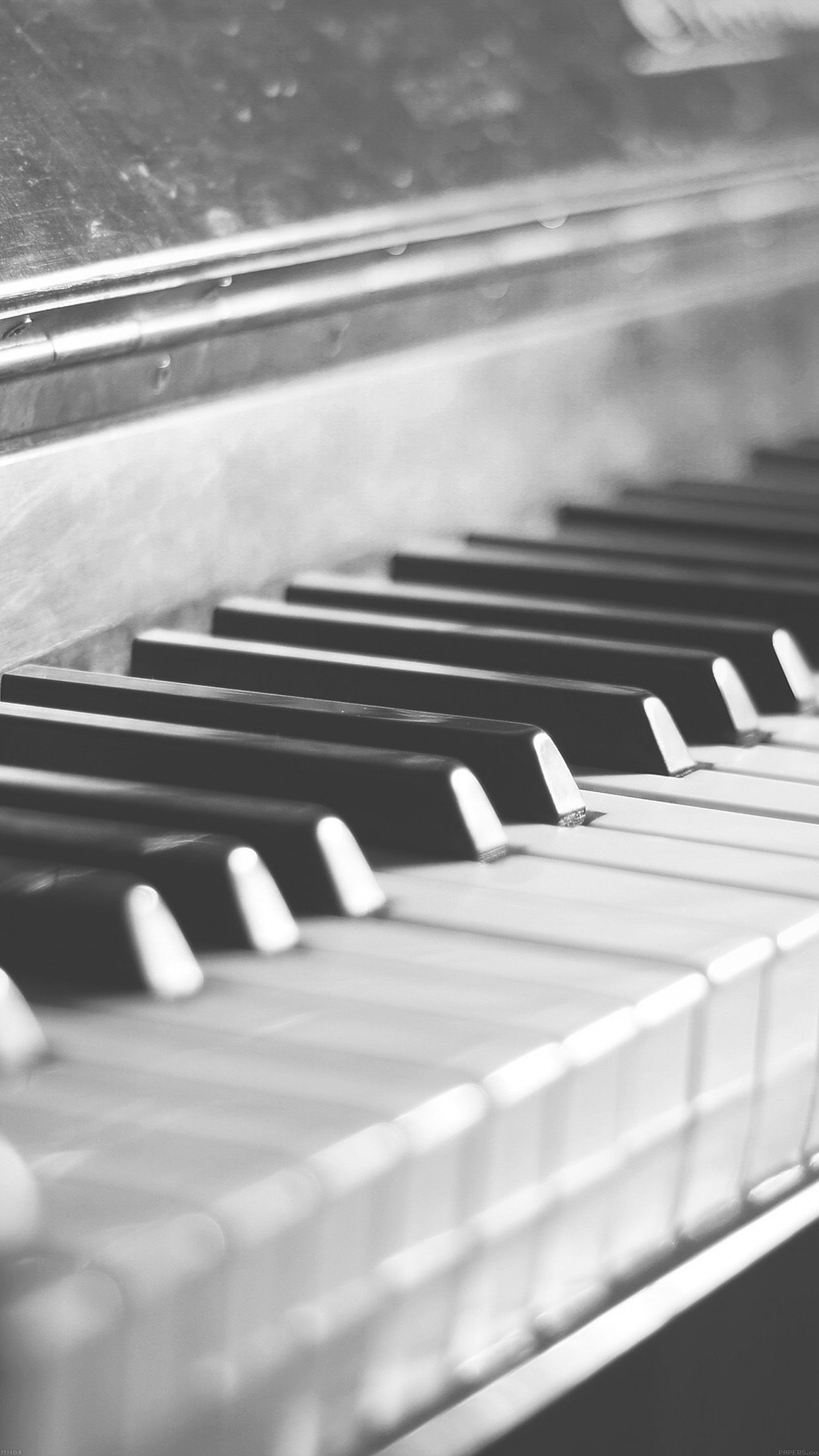 A black and white photo of an old piano - Piano