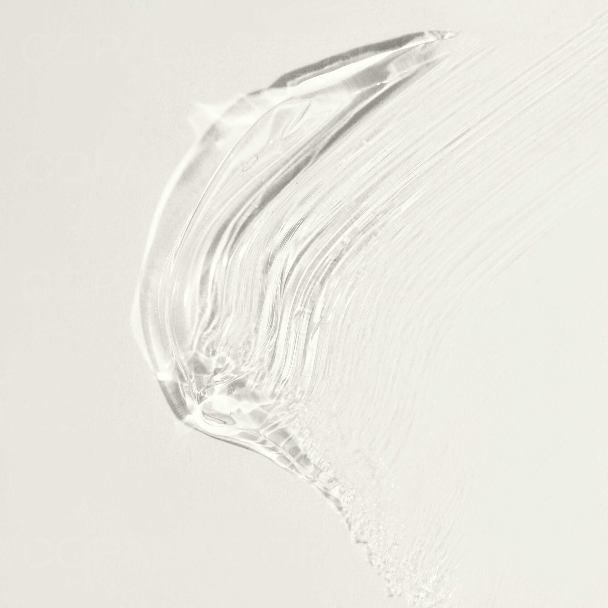 A white background with a clear white liquid on the right side. - Macro