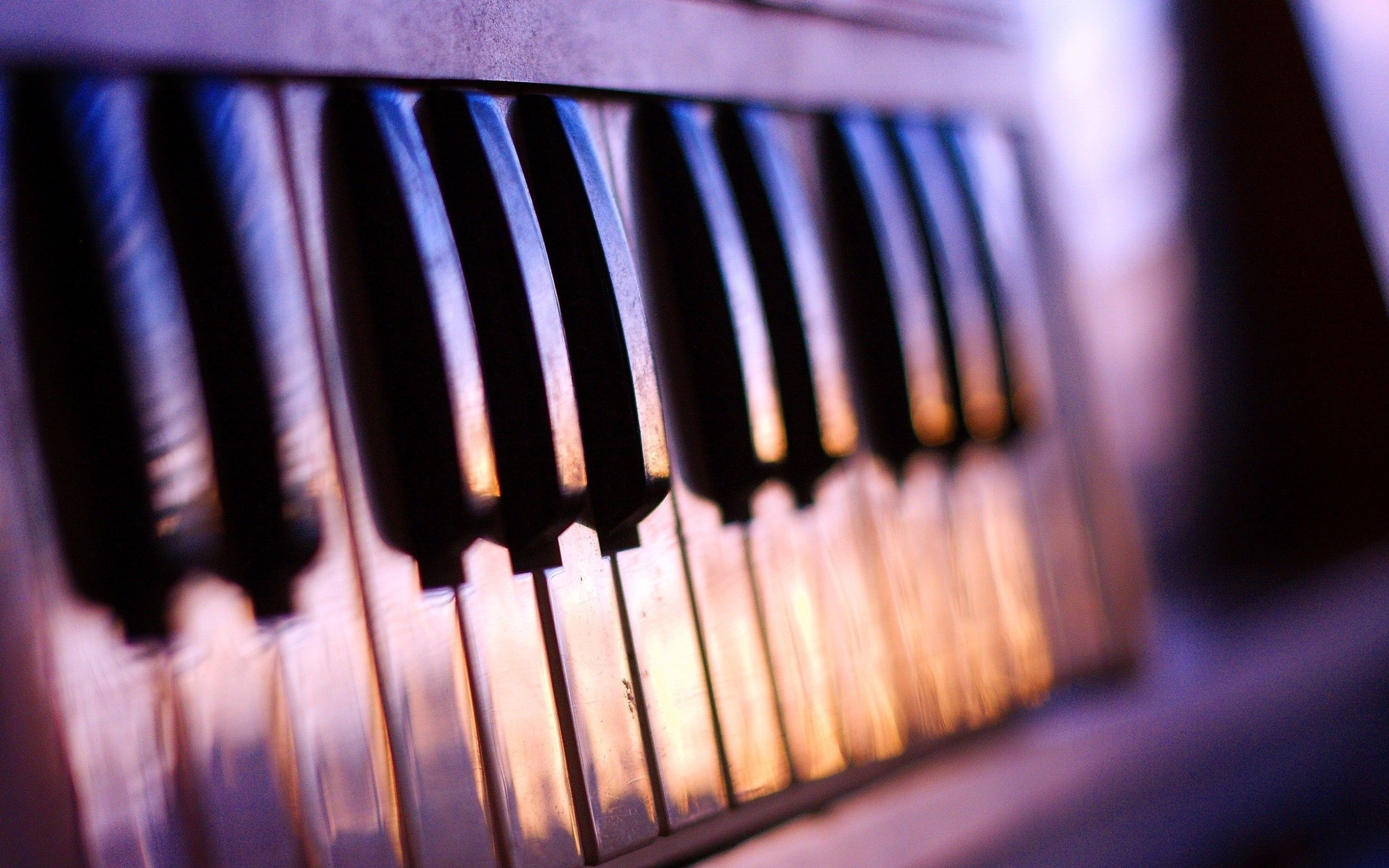 A close up of the keys on an old piano - Piano