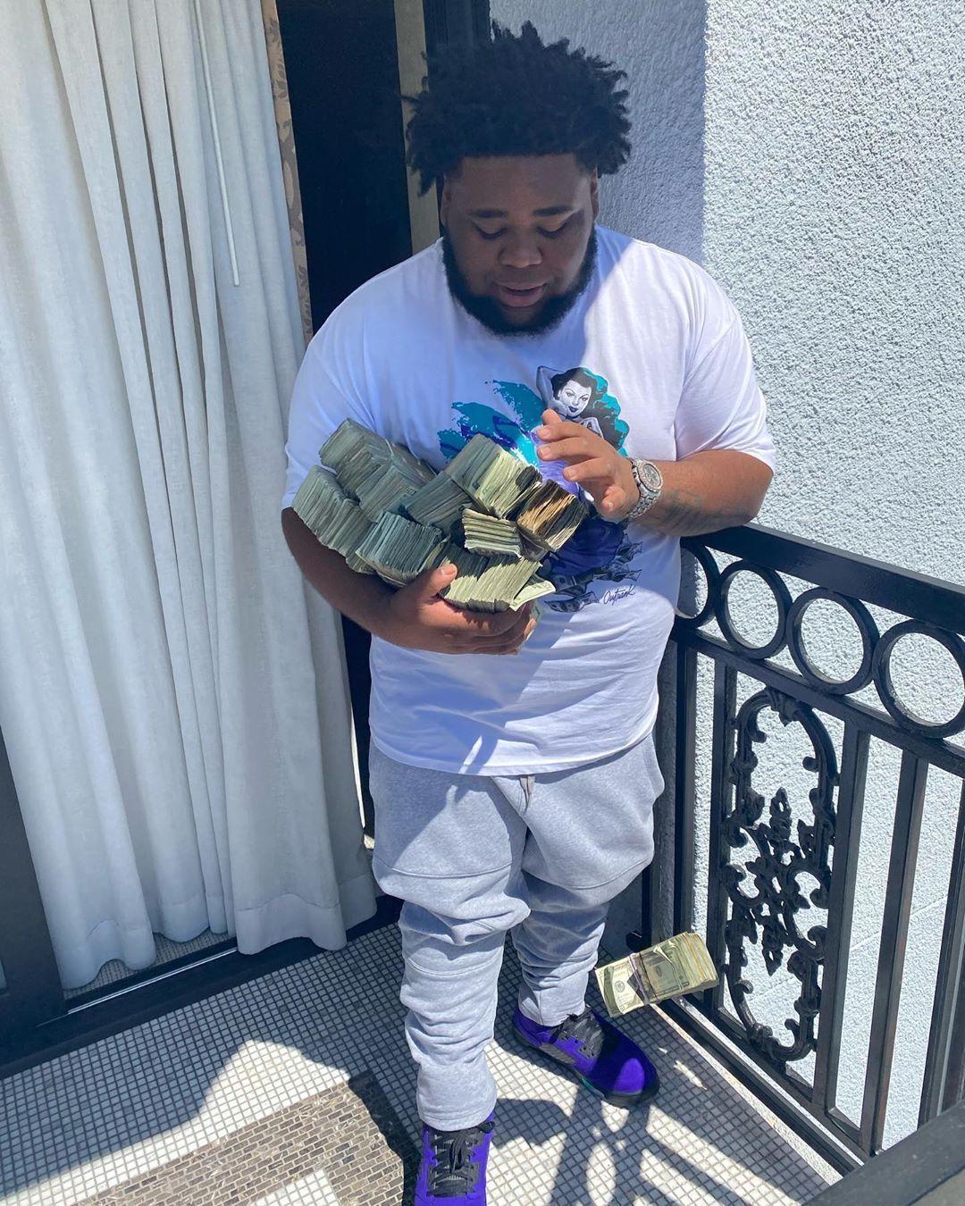 The rapper holding a pile of cash. - Rod Wave