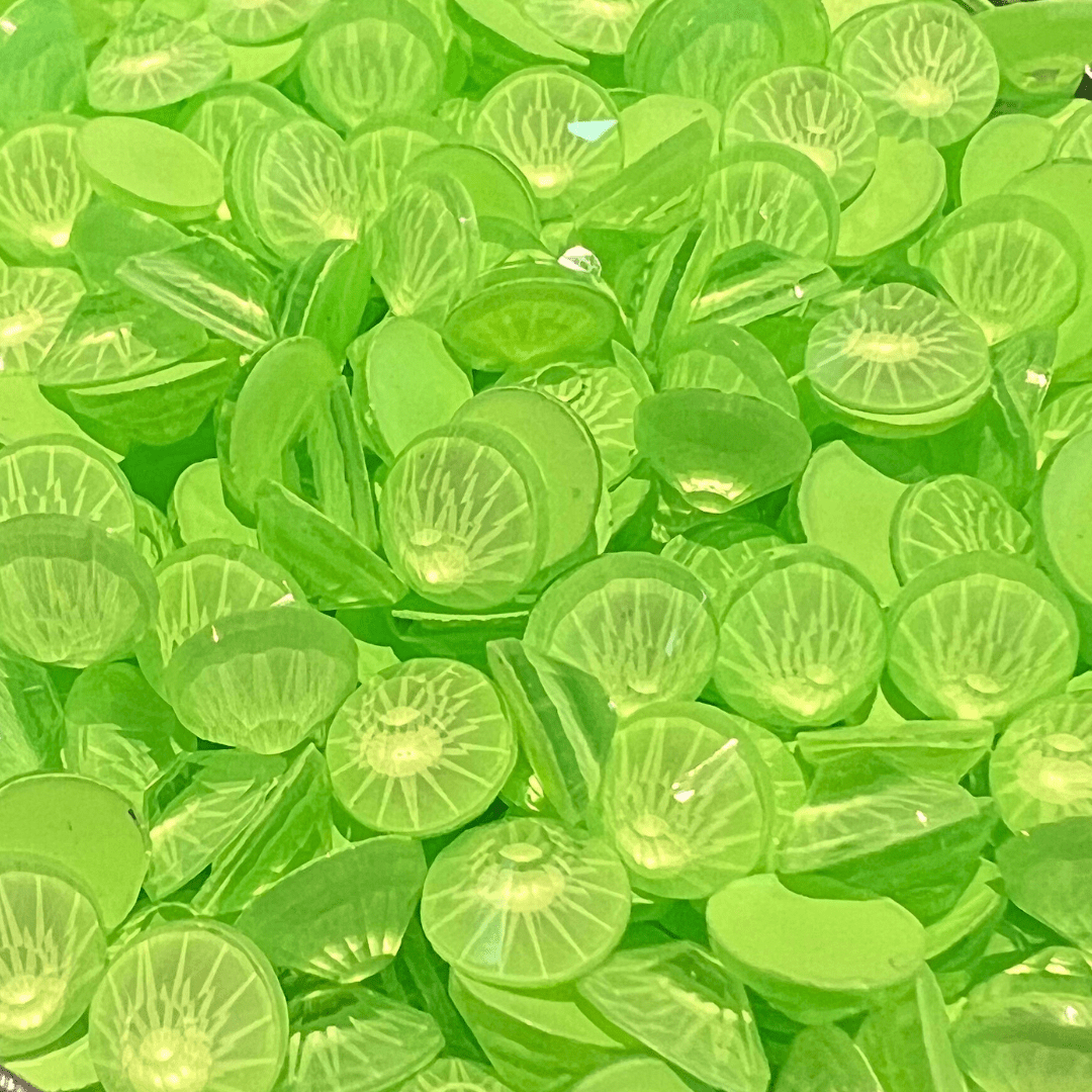 A pile of green translucent beads with a Kiwi design on them - Lime green