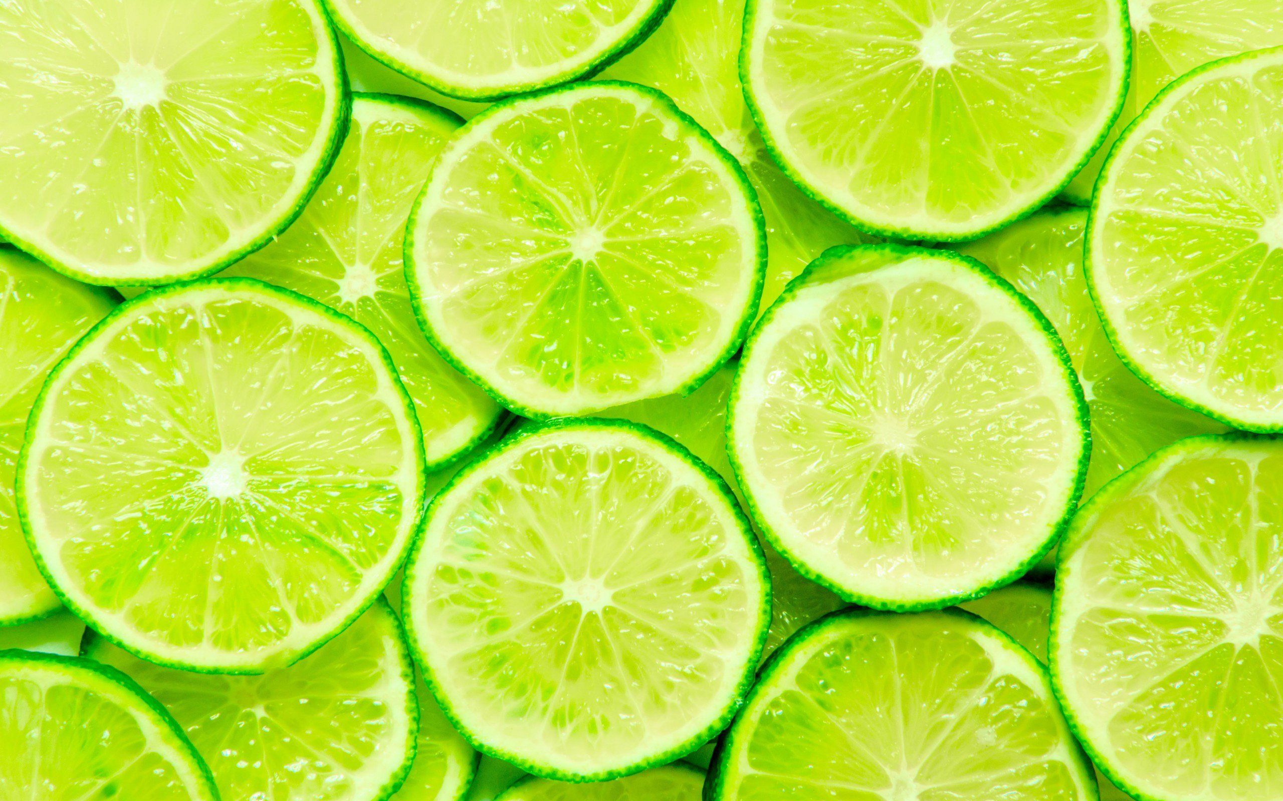Download wallpaper limes, green lemons, lemon wedges, tropical fruits, lemons, fruits, lemon textures, food textures, background with lemons for desktop with resolution 2560x1600. High Quality HD picture wallpaper. - Lime green