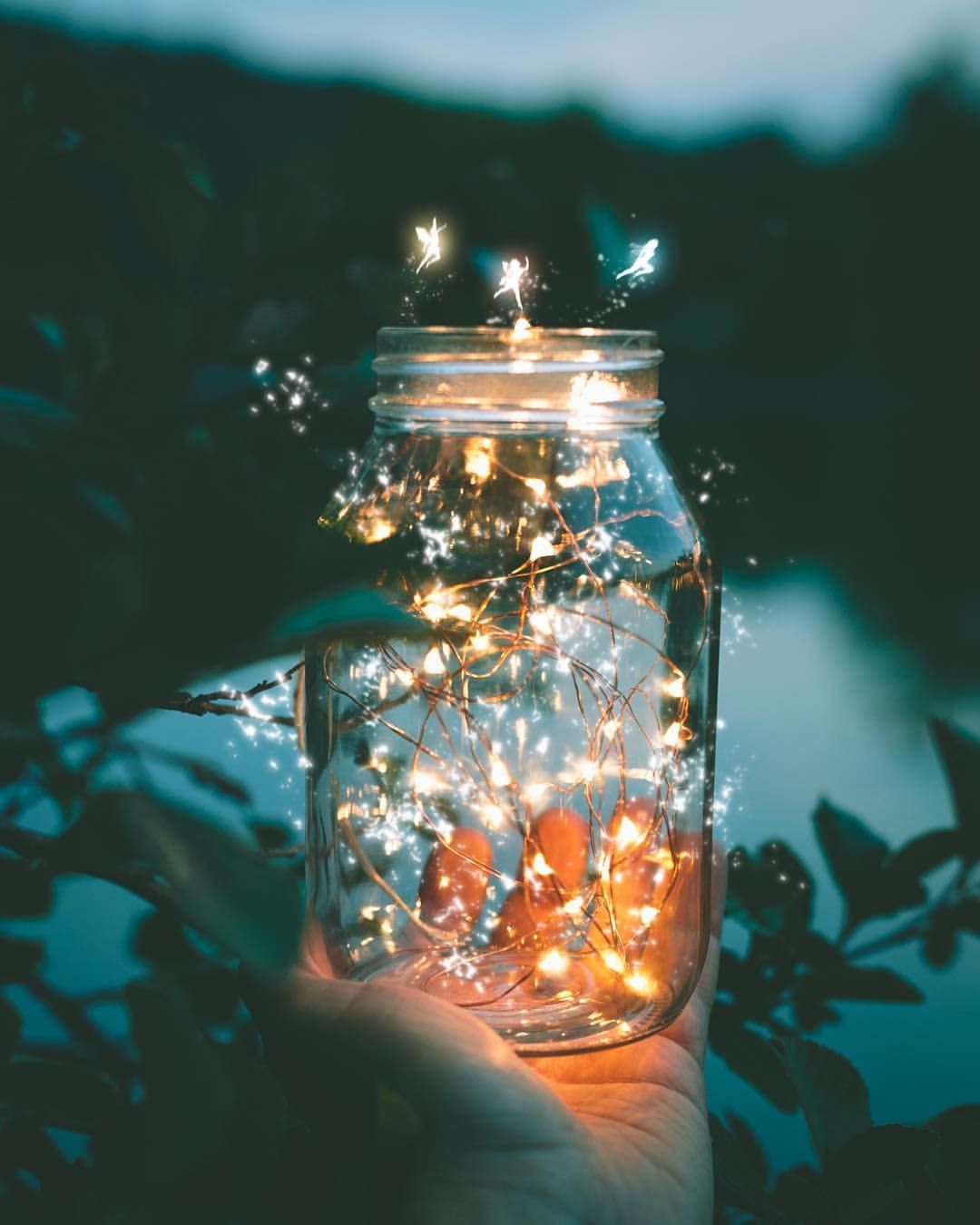 Hand holding a jar with lights inside - Fairy lights