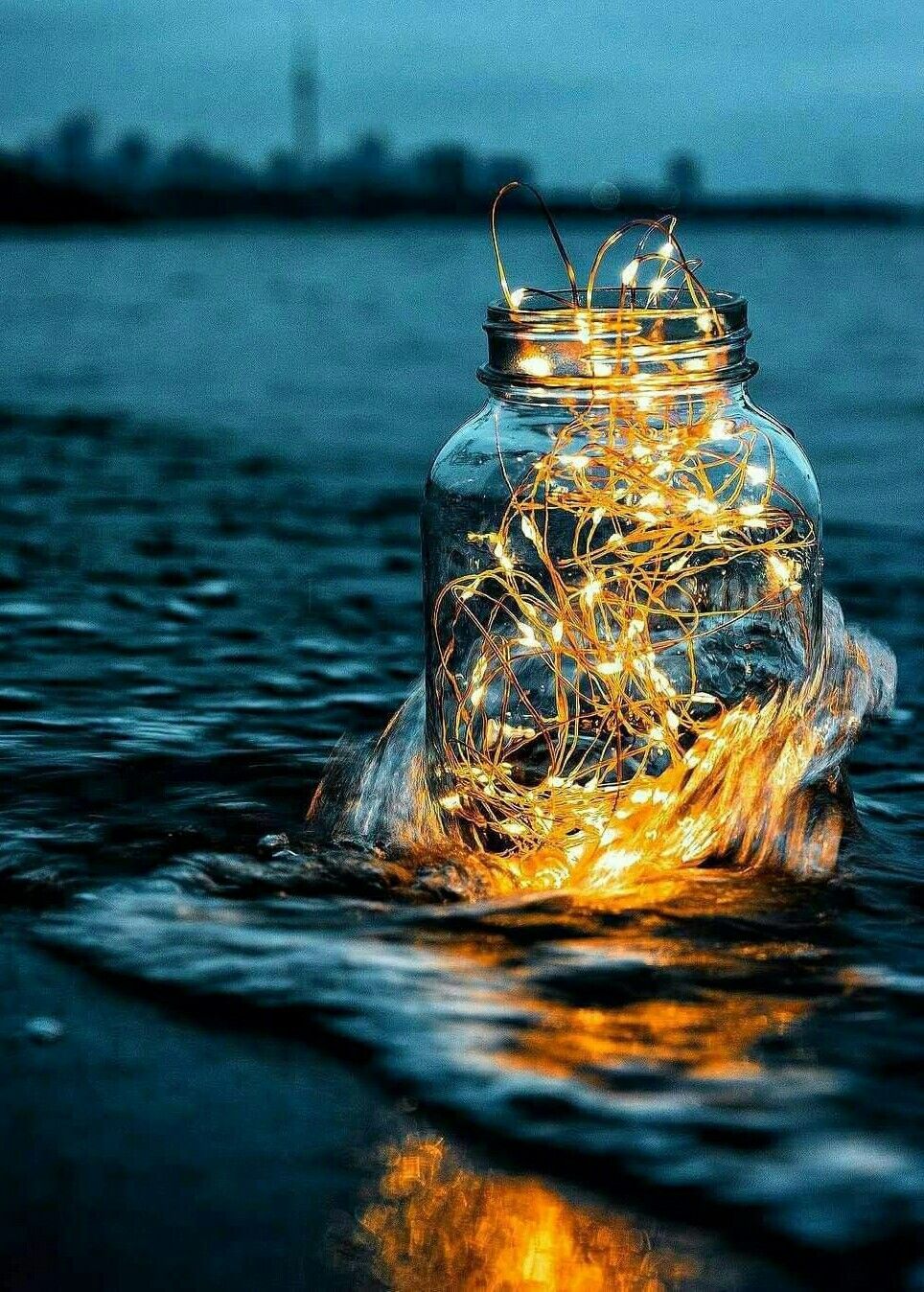 A jar filled with fairy lights floating on the water - Fairy lights