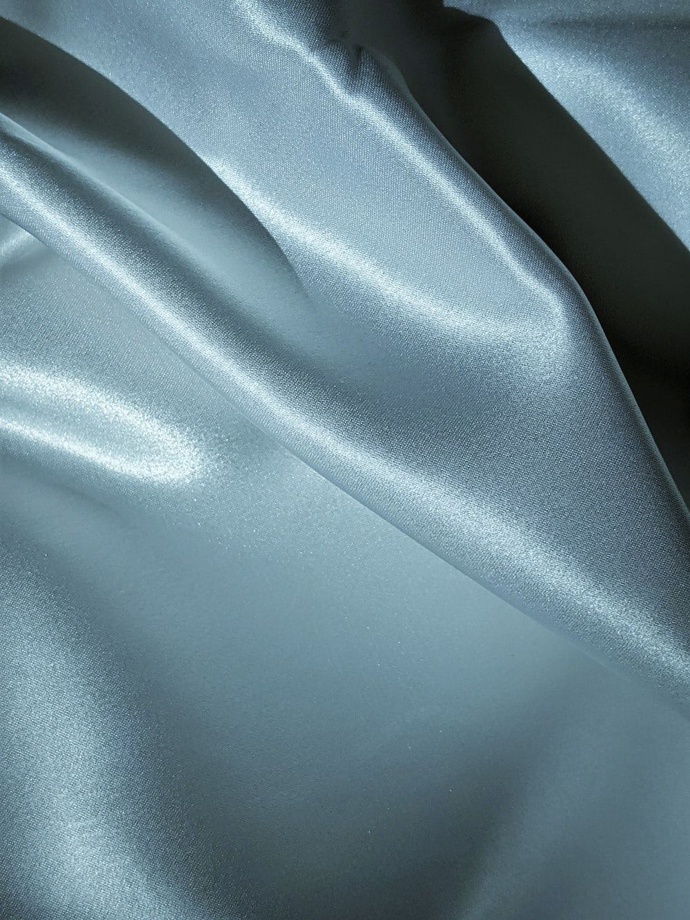 A close up of a silver silk sheet. - Silk