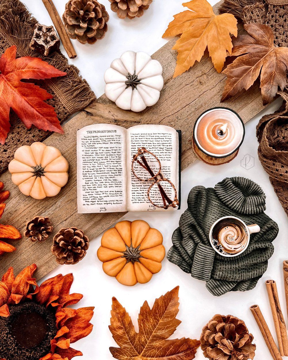 A book, a cup of coffee, and autumn leaves - Flat lay