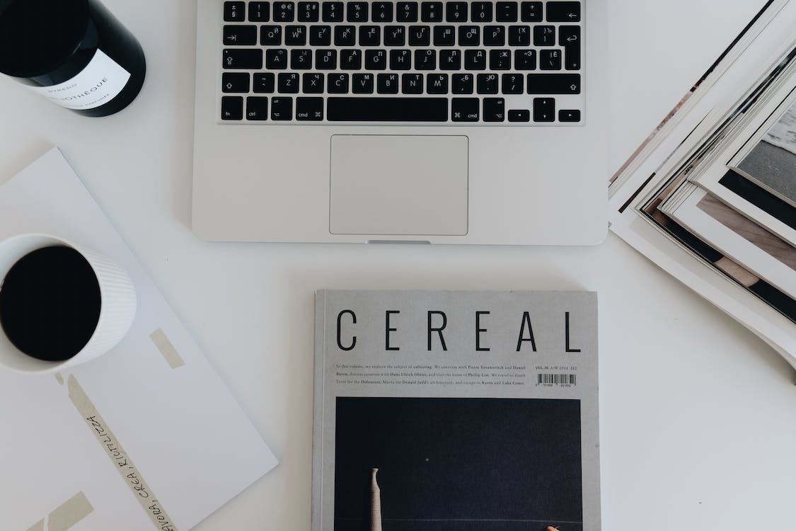 A Flatlay of Magazines and a Laptop · Free