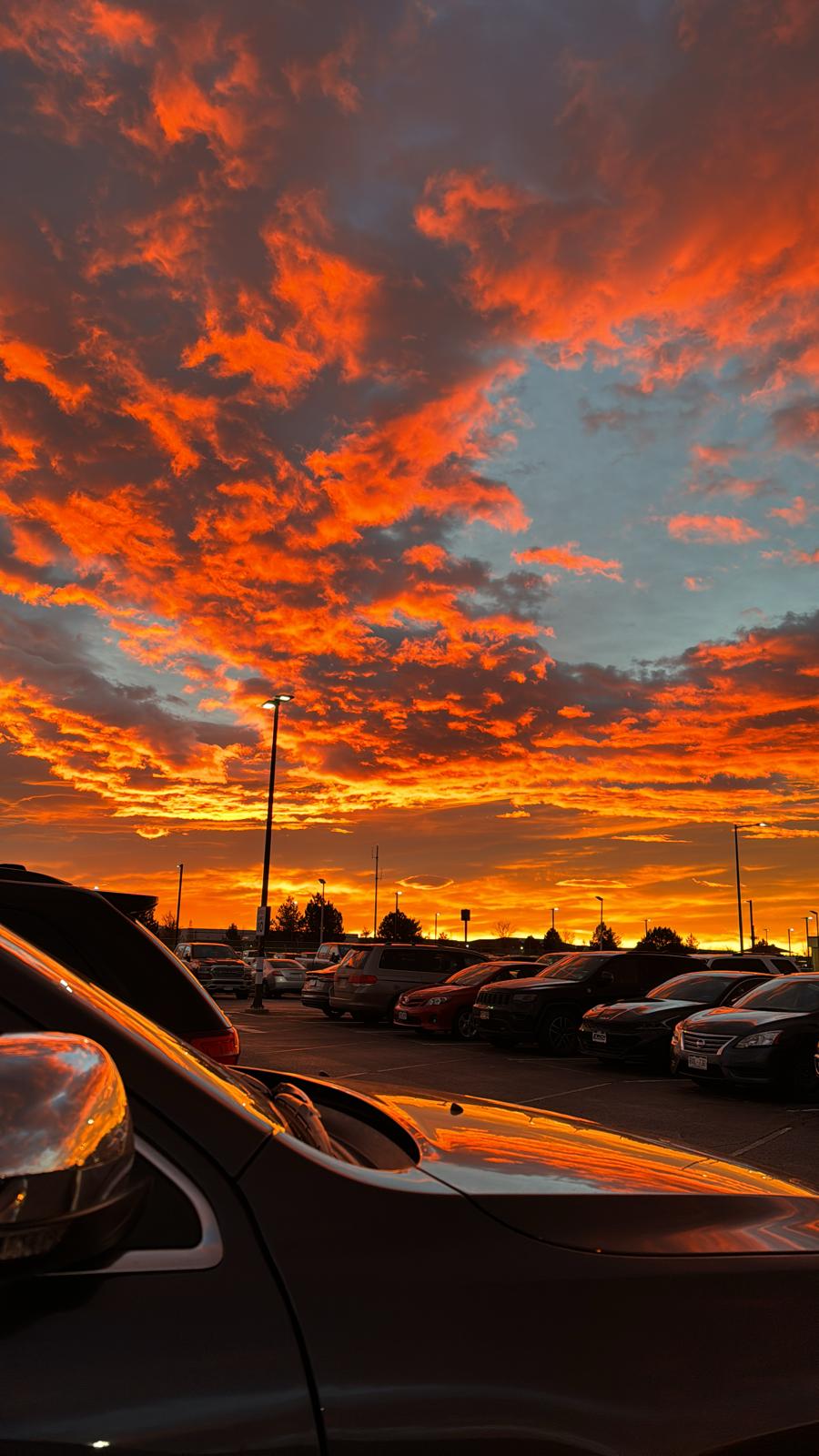 A red and orange sunset over a parking lot - Sunrise