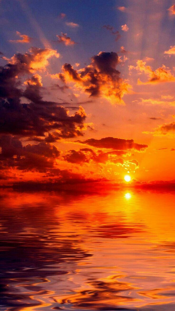 A beautiful sunset with clouds and water. - Sunrise