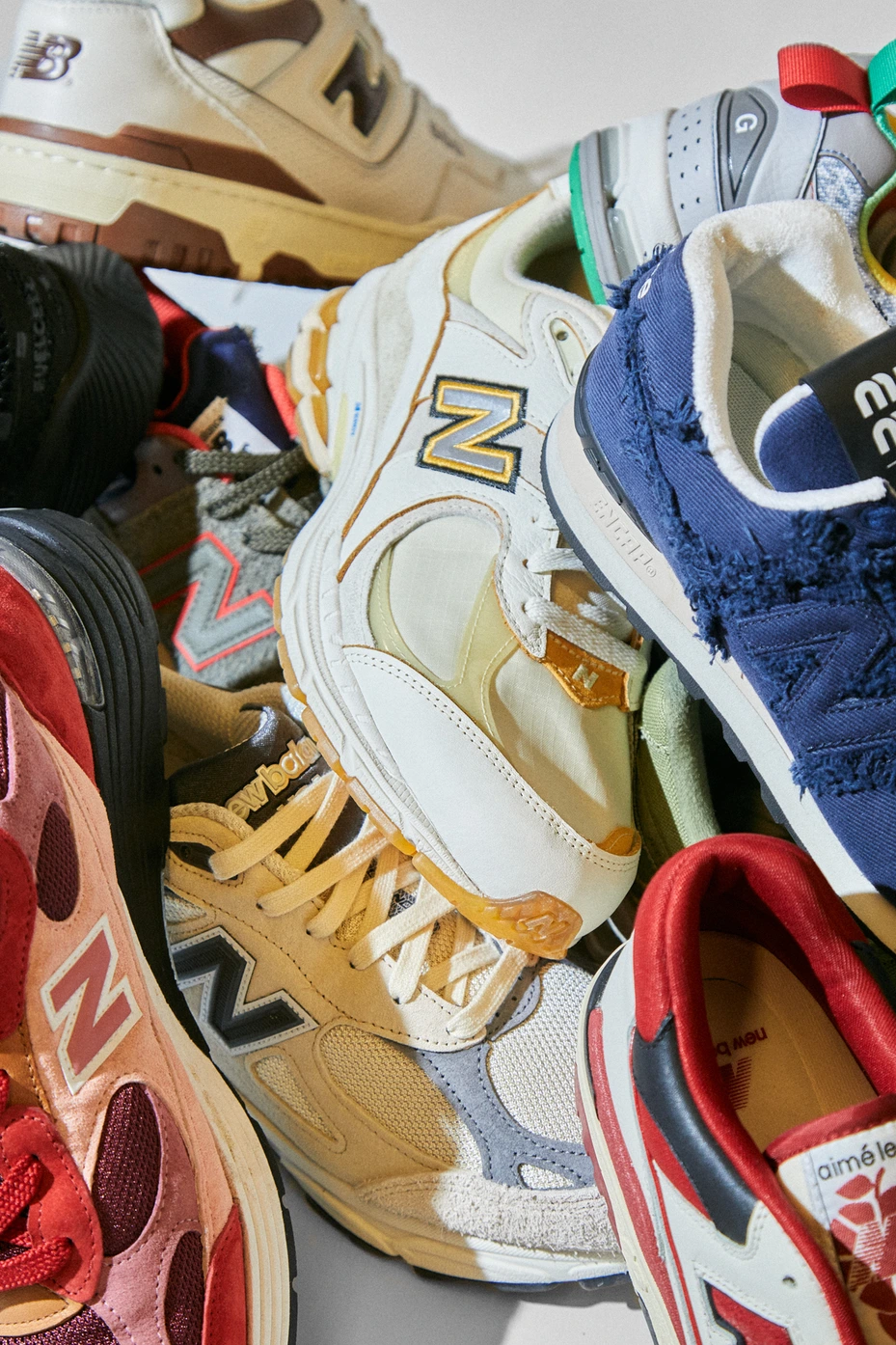 A pile of variously colored New Balance sneakers - New Balance