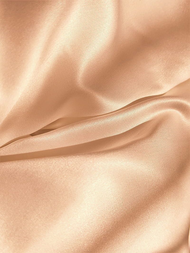 A close up of a champagne colored silk sheet set. - Silk
