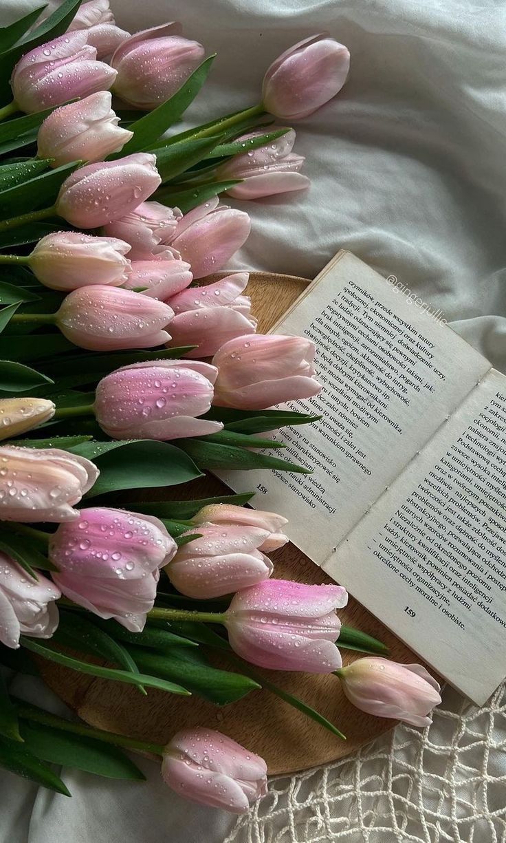A book with pink flowers on a table. - Coquette