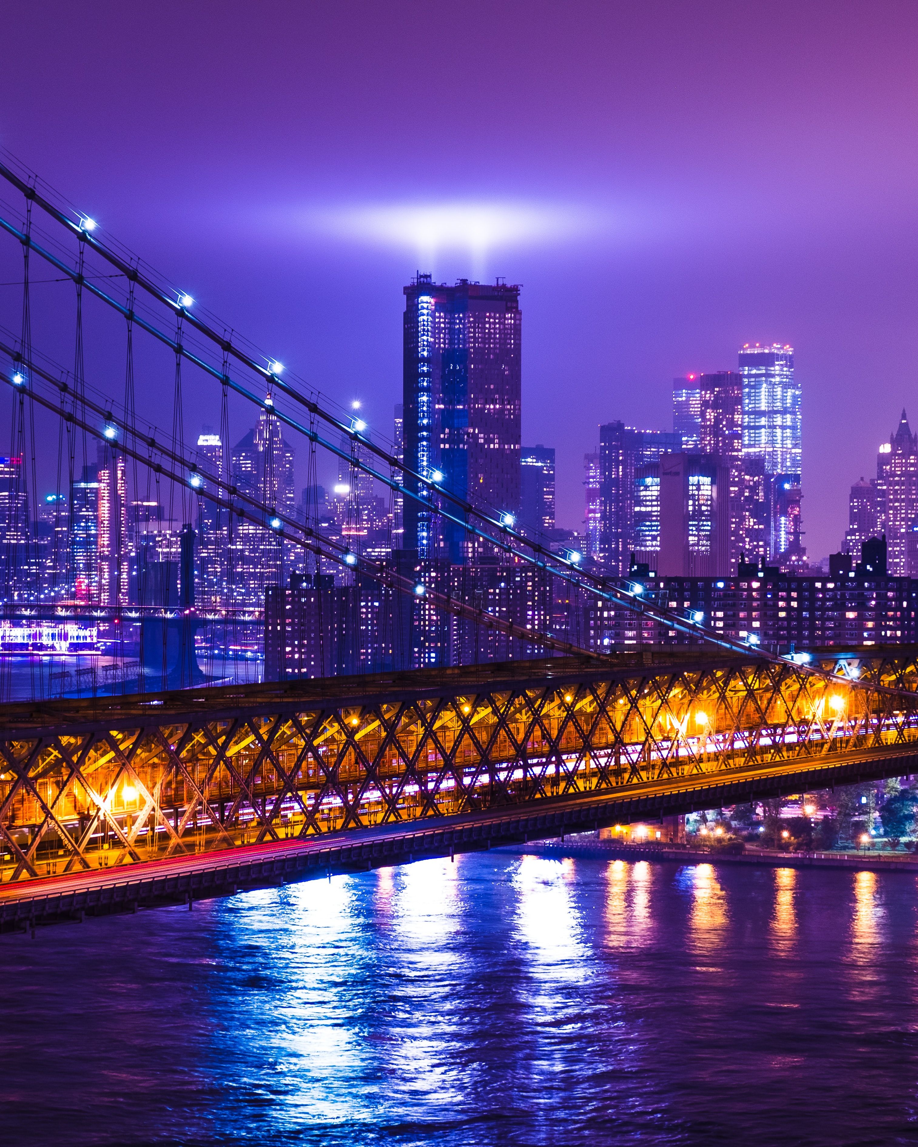 A night view of the Brooklyn Bridge and the city of New York. - New York