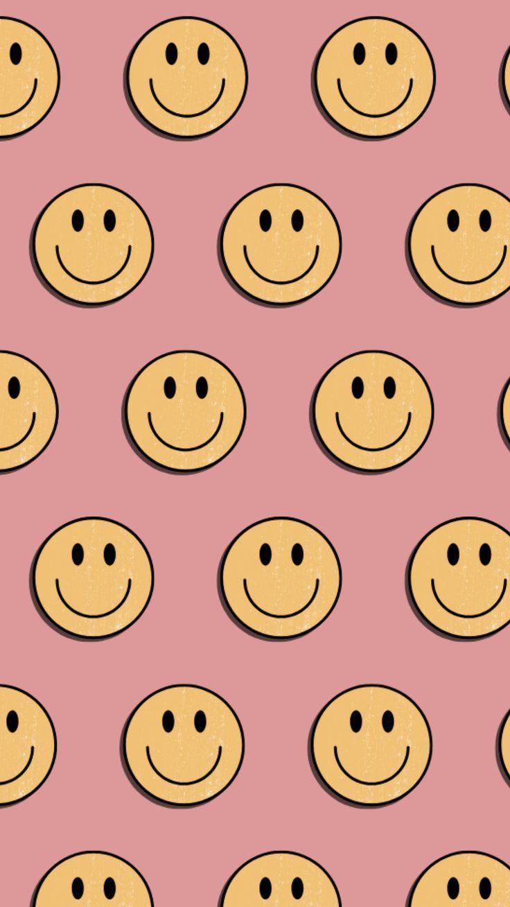 A pink background with smiley faces on it - Smiley