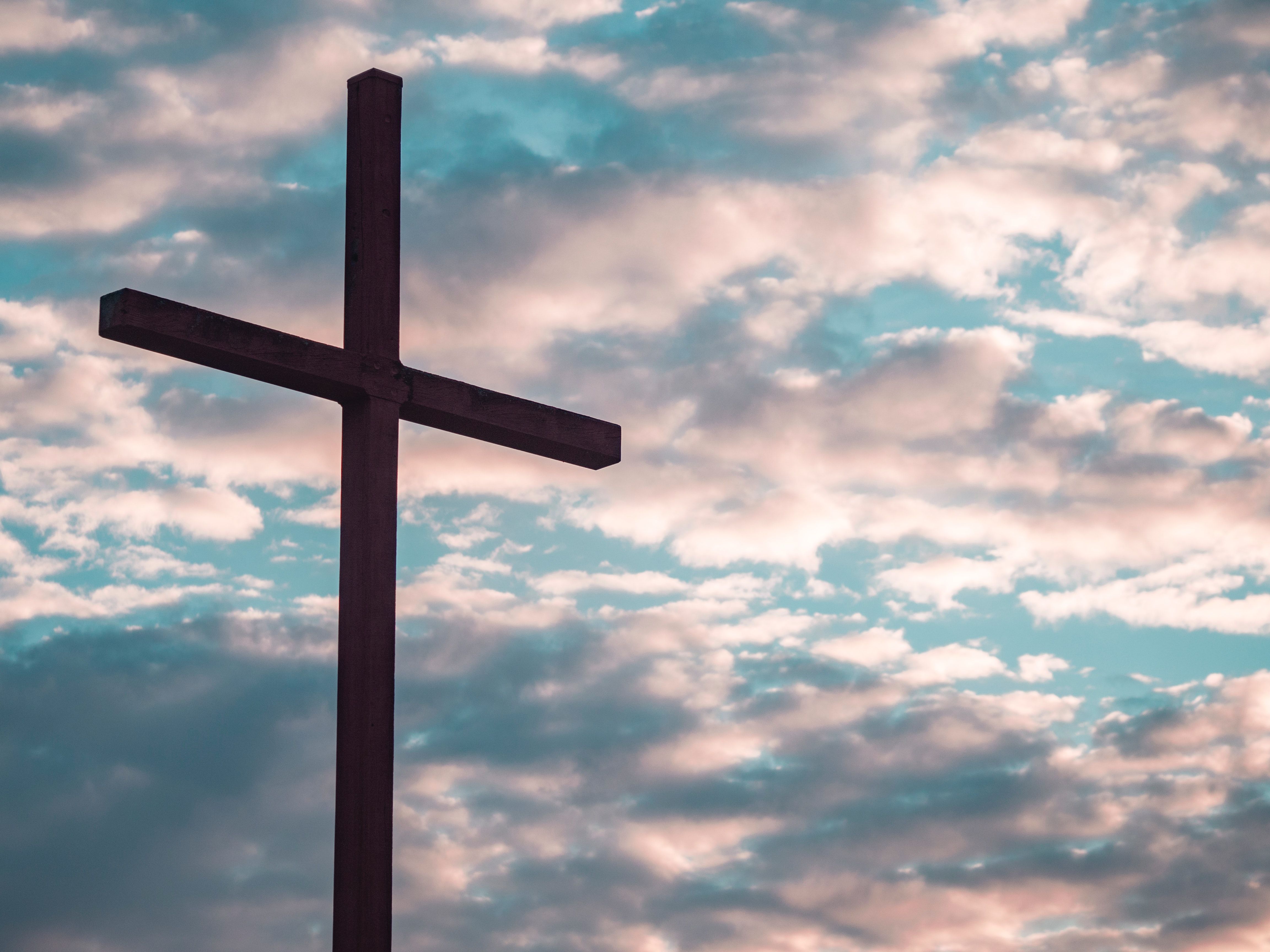 A wooden cross against a cloudy sky - Cross