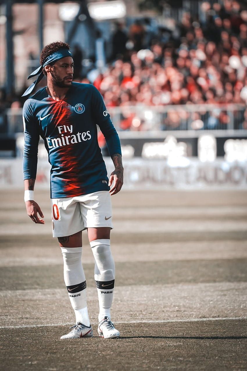 A man standing on top of a soccer field. - Neymar