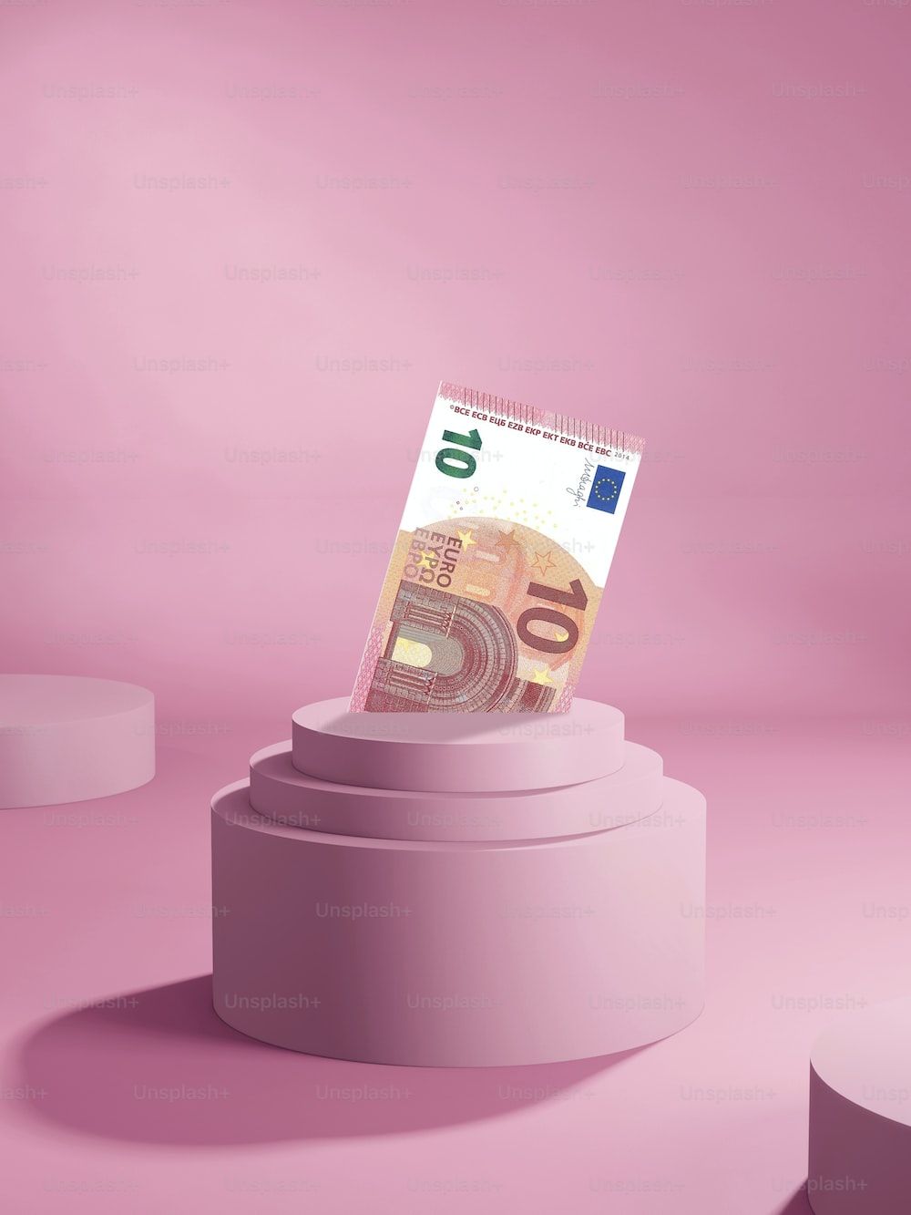 Euro banknote on a pink podium - Money