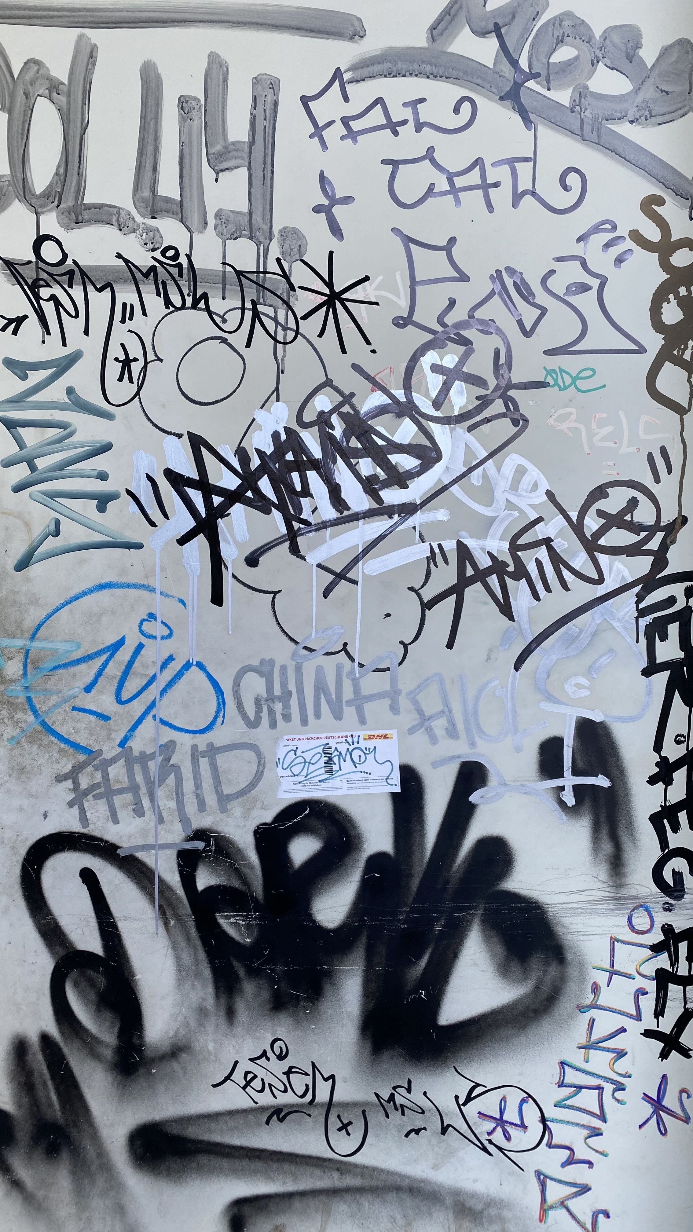A wall covered in various graffiti tags - Graffiti