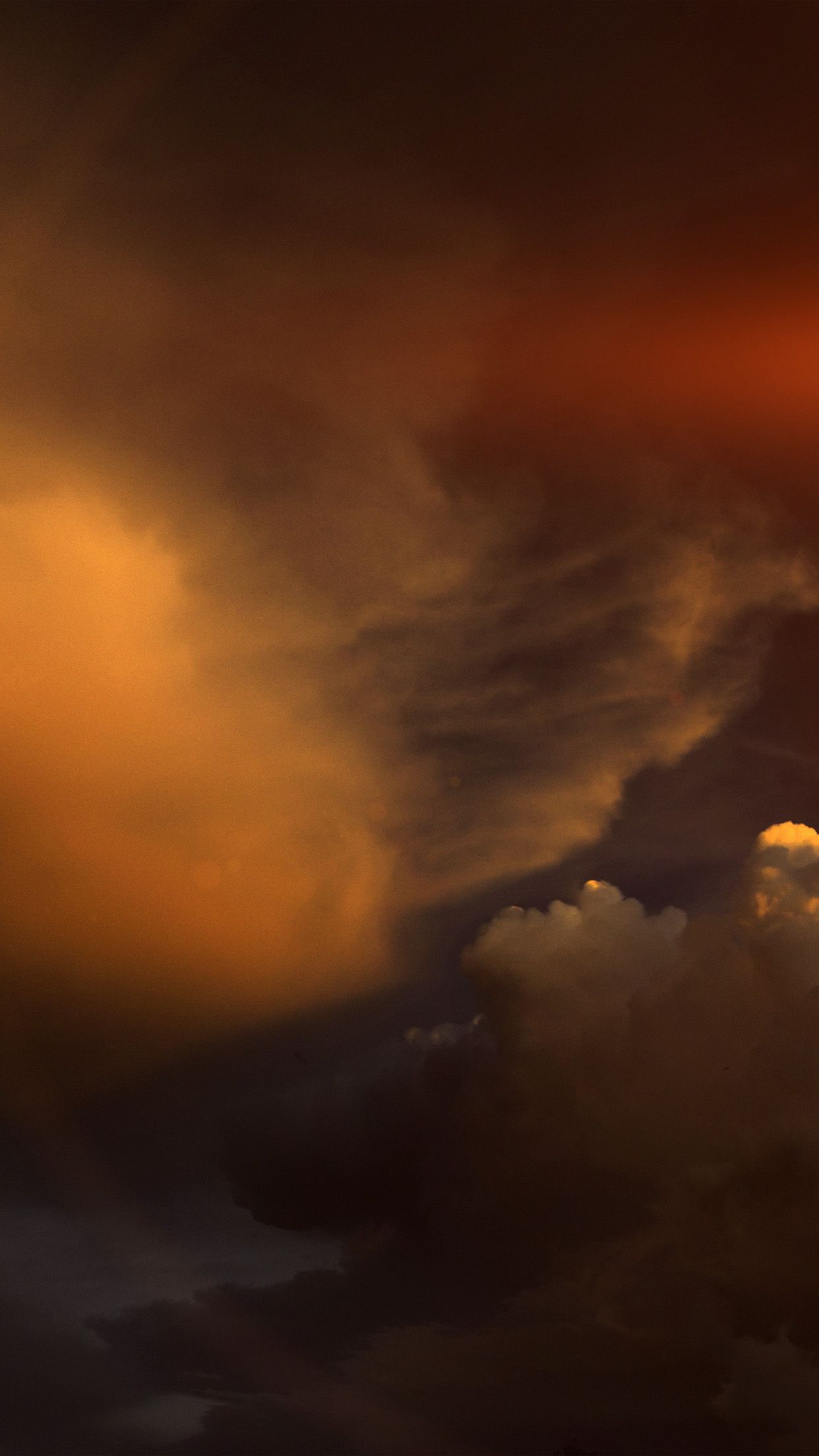 A dark and moody photo of clouds with a hint of orange in the sky. - Light brown, warm, sky, cloud